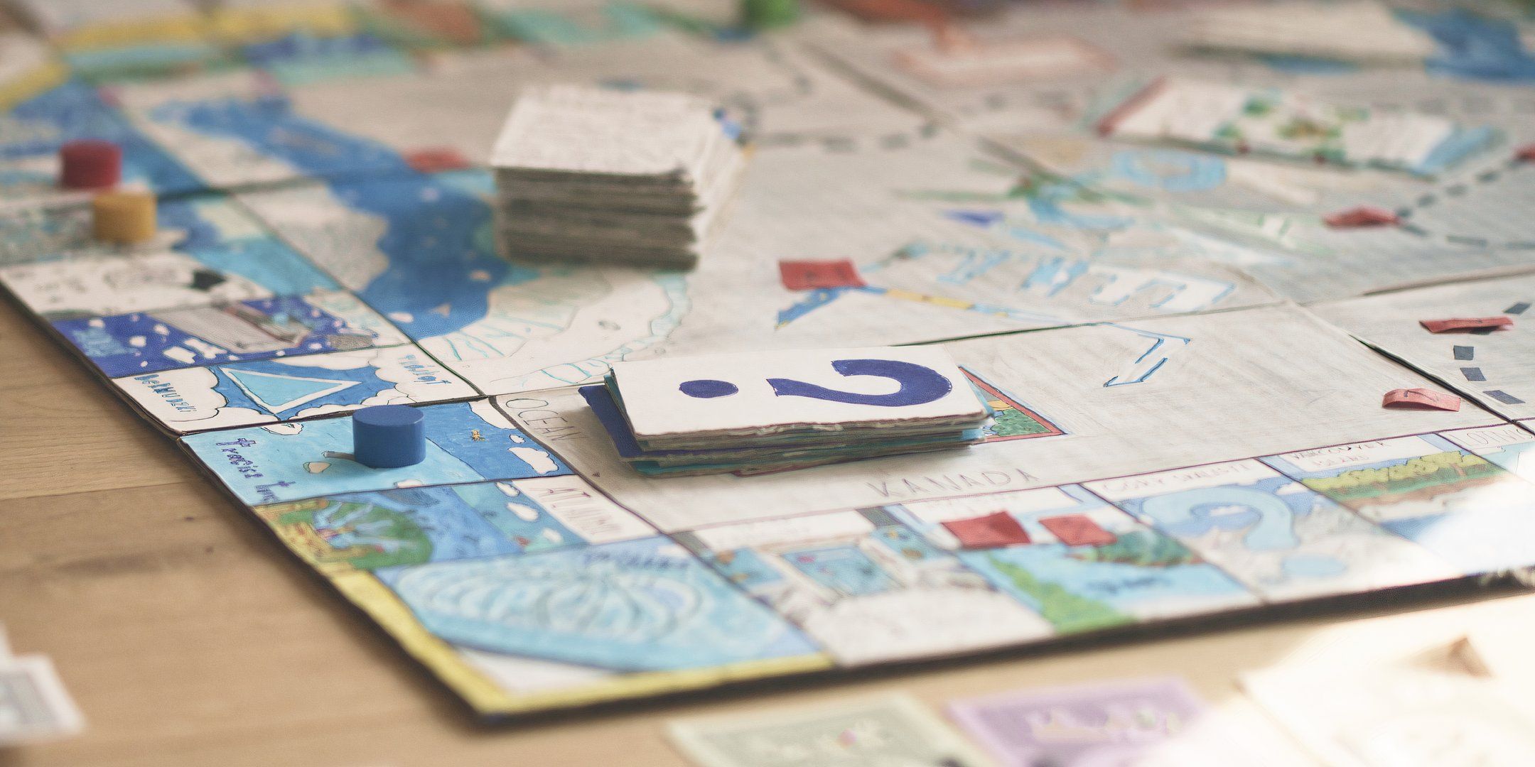 Homemade board game with paper and drawings.
