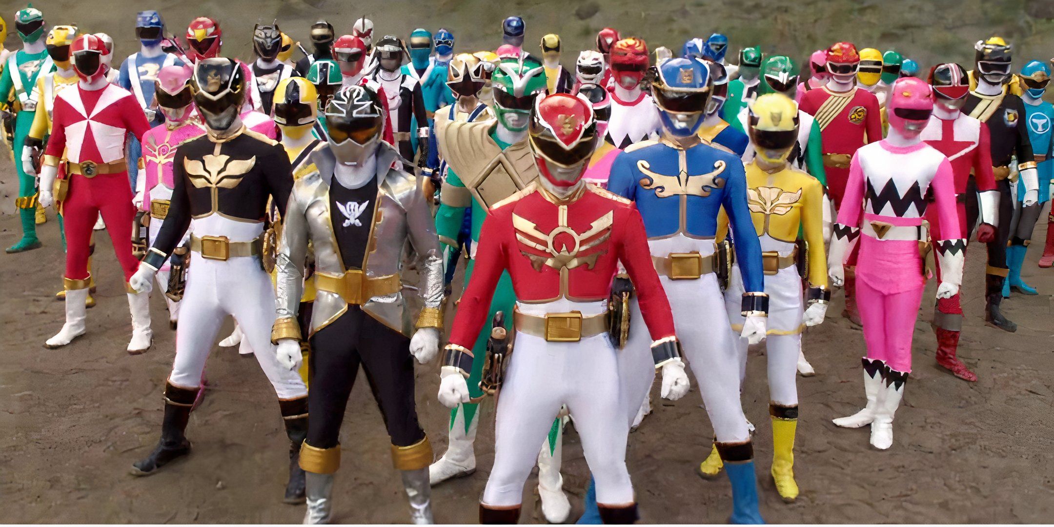 The Legendary Rangers stand in a large group. They are all varying colors. The background is all dirt.