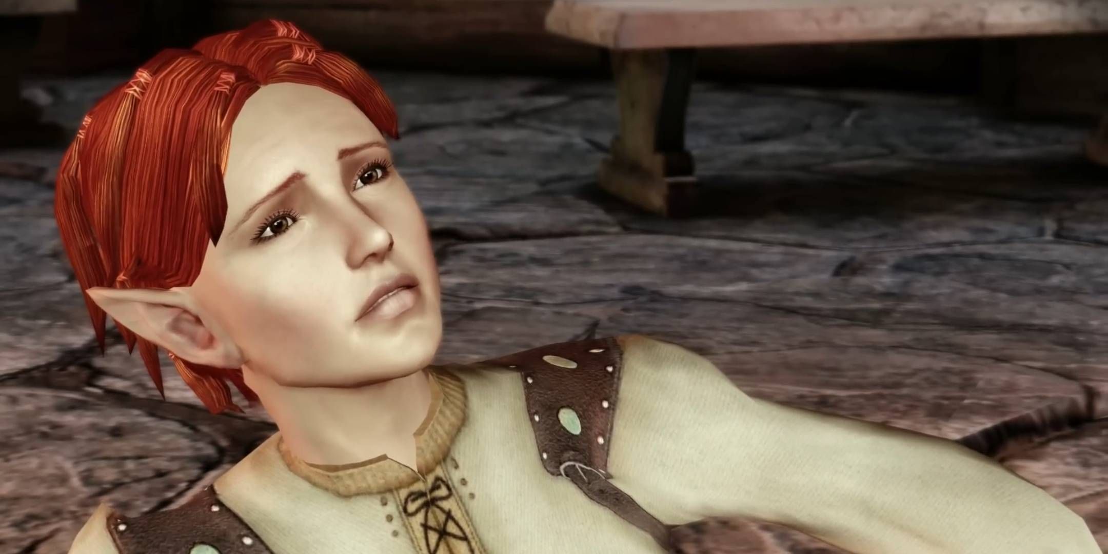 Shianni on the ground frowning from the city elf origin in Dragon Age: Origins