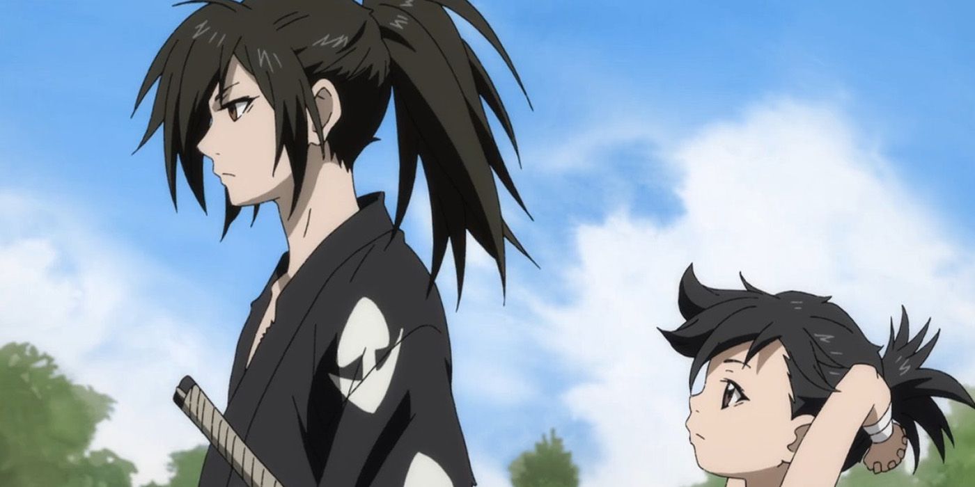 Hyakkimaru wears a black and white kimono. Dororo, a small child, walks behind him.