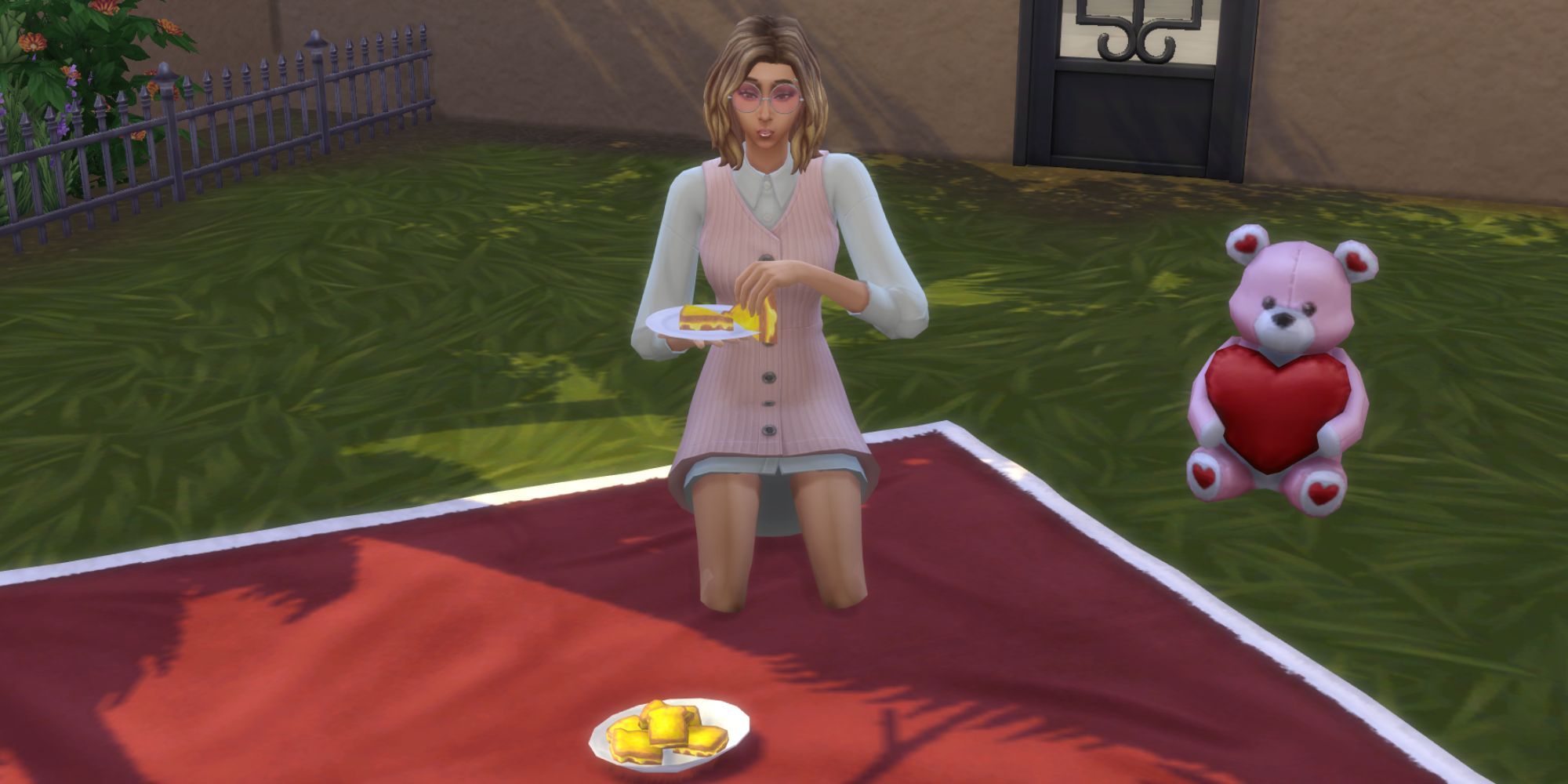 A Sim eats grilled cheese on a blanket next to a heart teddy bear.