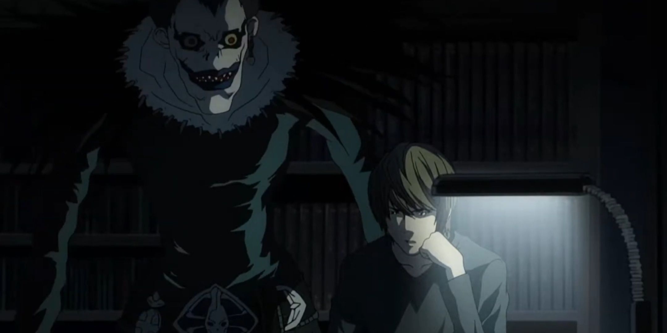 Ryuk standing behind Light Yagami in Death Note.