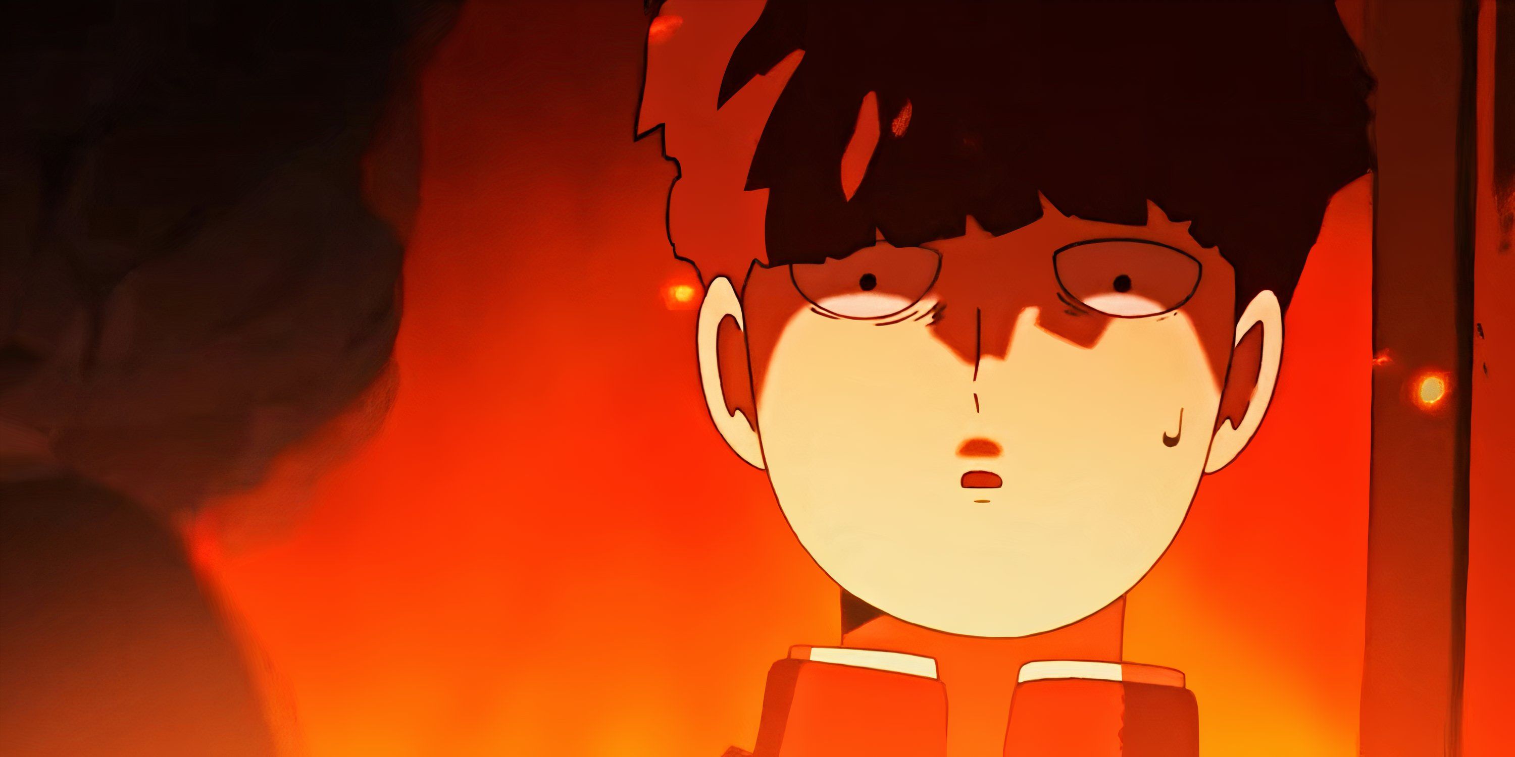 Mob, his face aglow, giving a confused look in Mob Psycho 100.