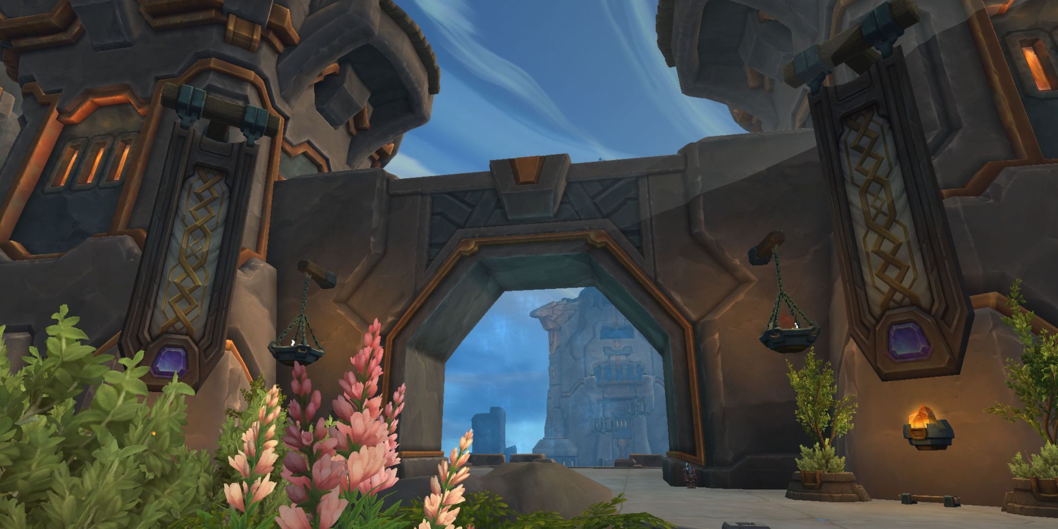 The entrance to the Rooker dungeon in World of Warcraft. Flowers sit near the entrance.