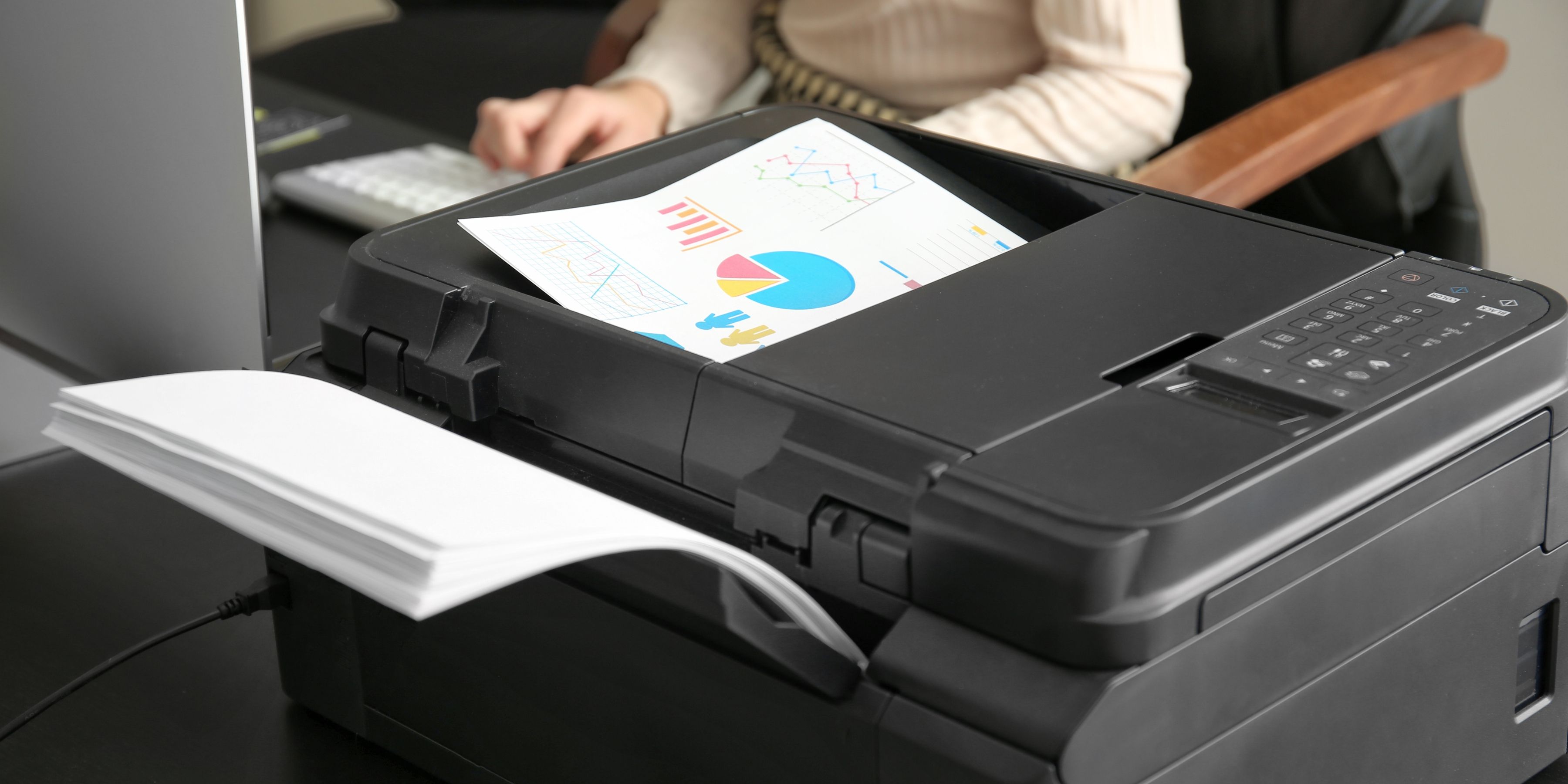 Image of person printing chart reports.