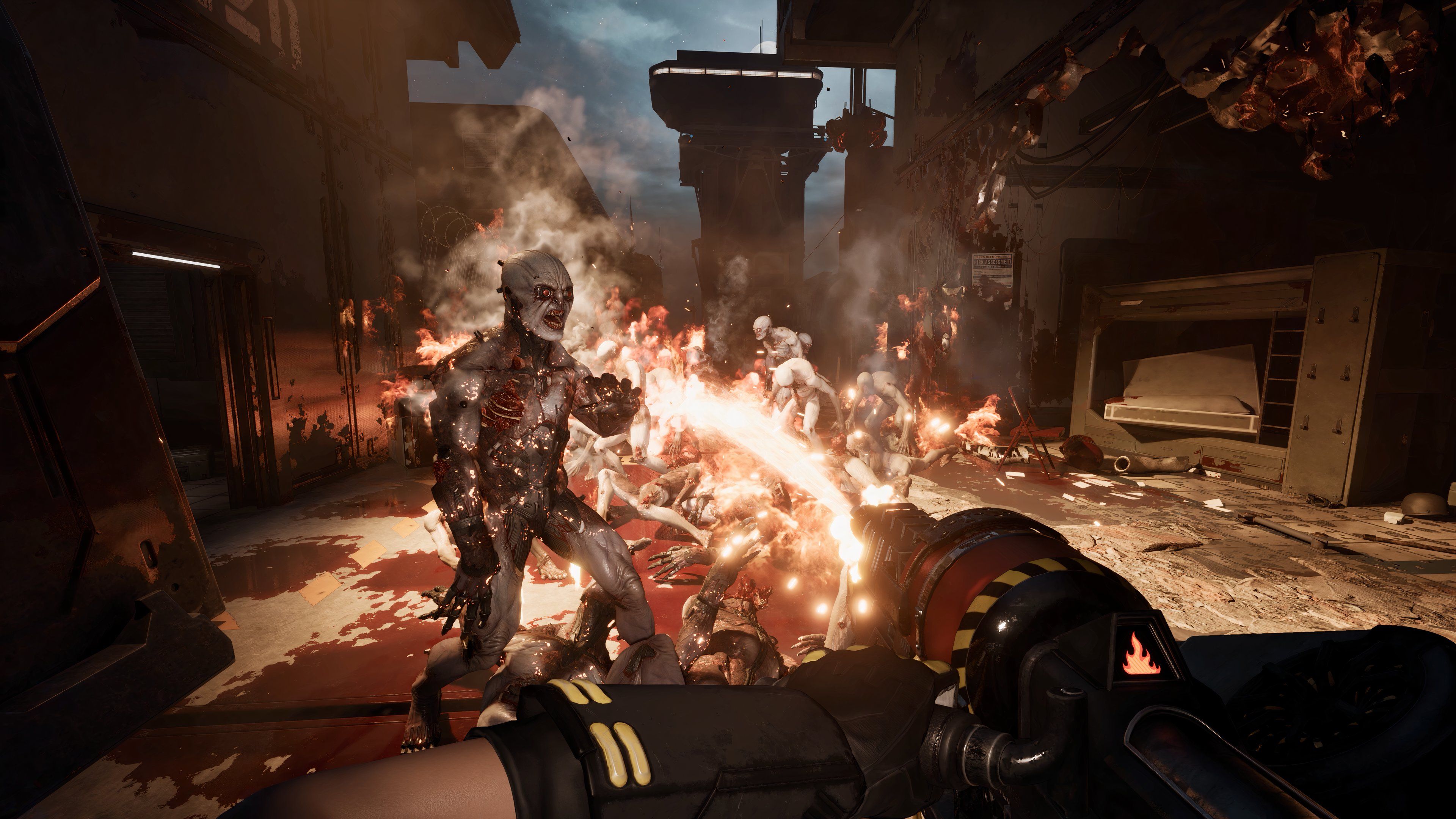 A group of Zeds being incinerated by the player using a flamethrower.