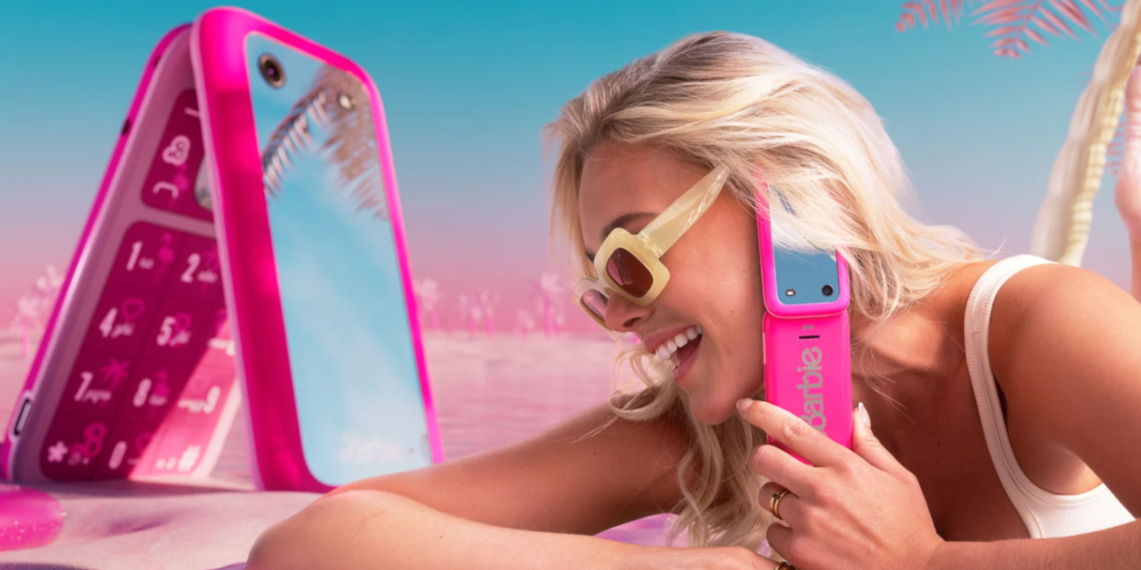 woman using a nokia barbie phone with a big version behind her