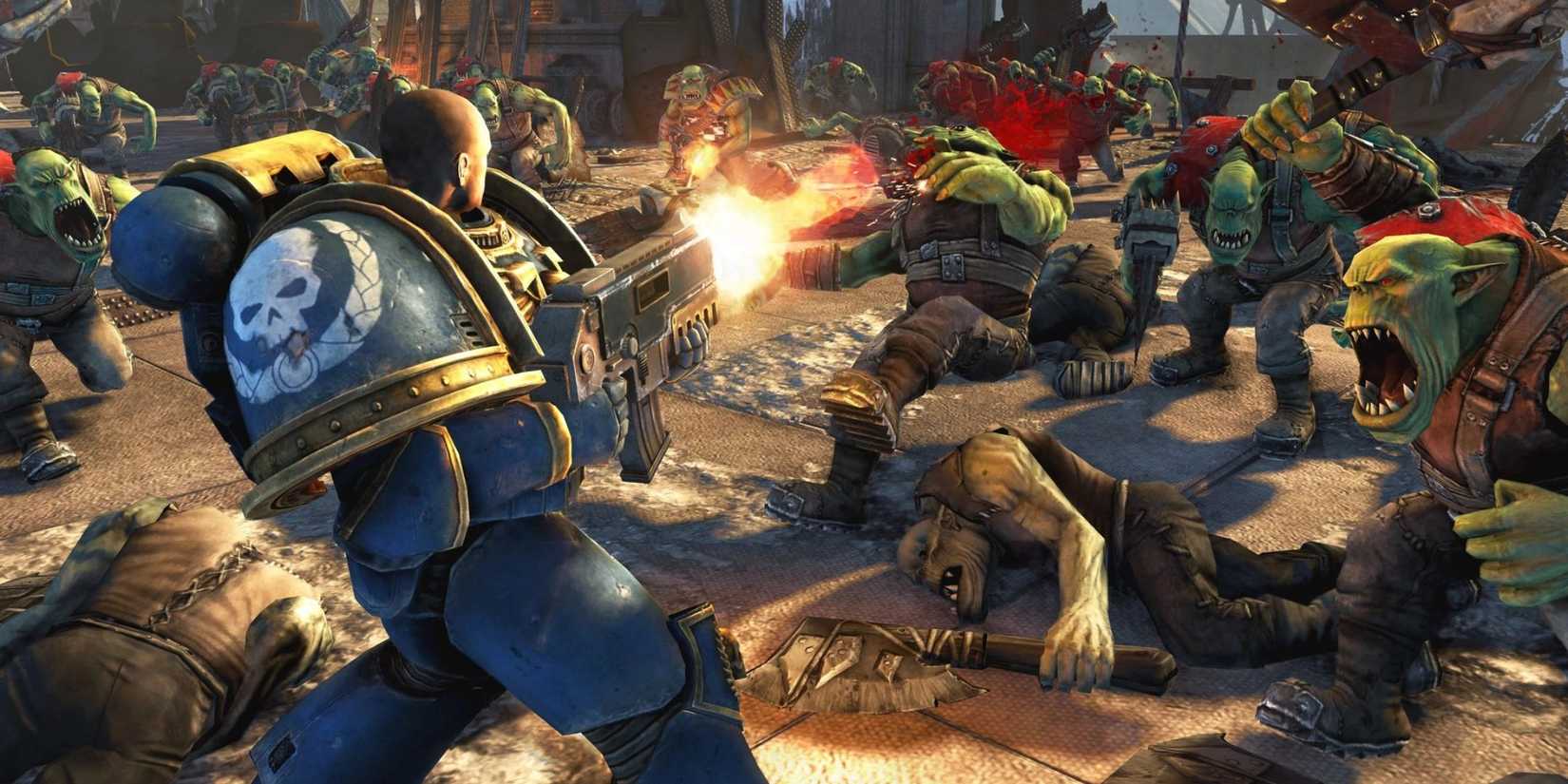 An ultramarine shoots down orks with a bolter.