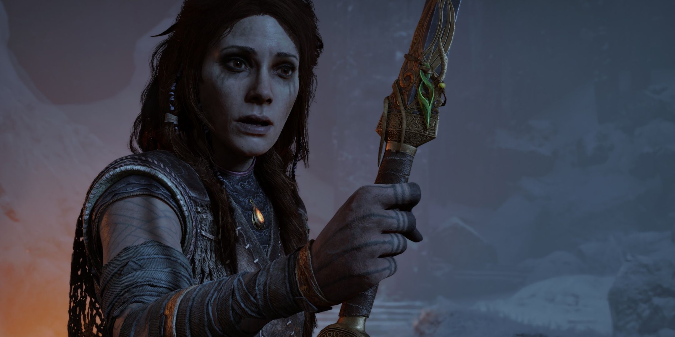 Freya looking at Atreus' necklace in God of War: Ragnarok.