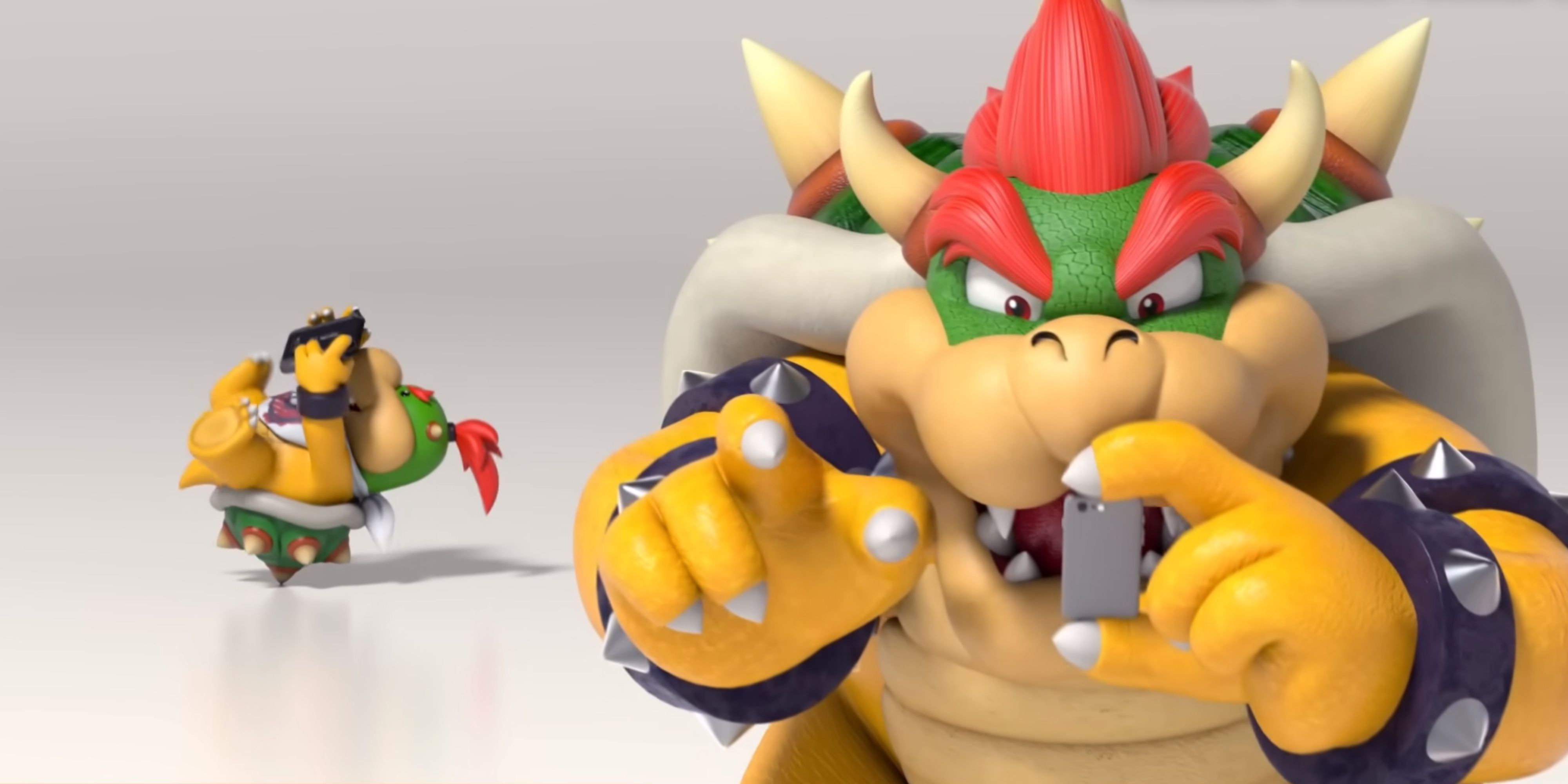 bowser using a smartphone and bowser jr playing a switch behind him