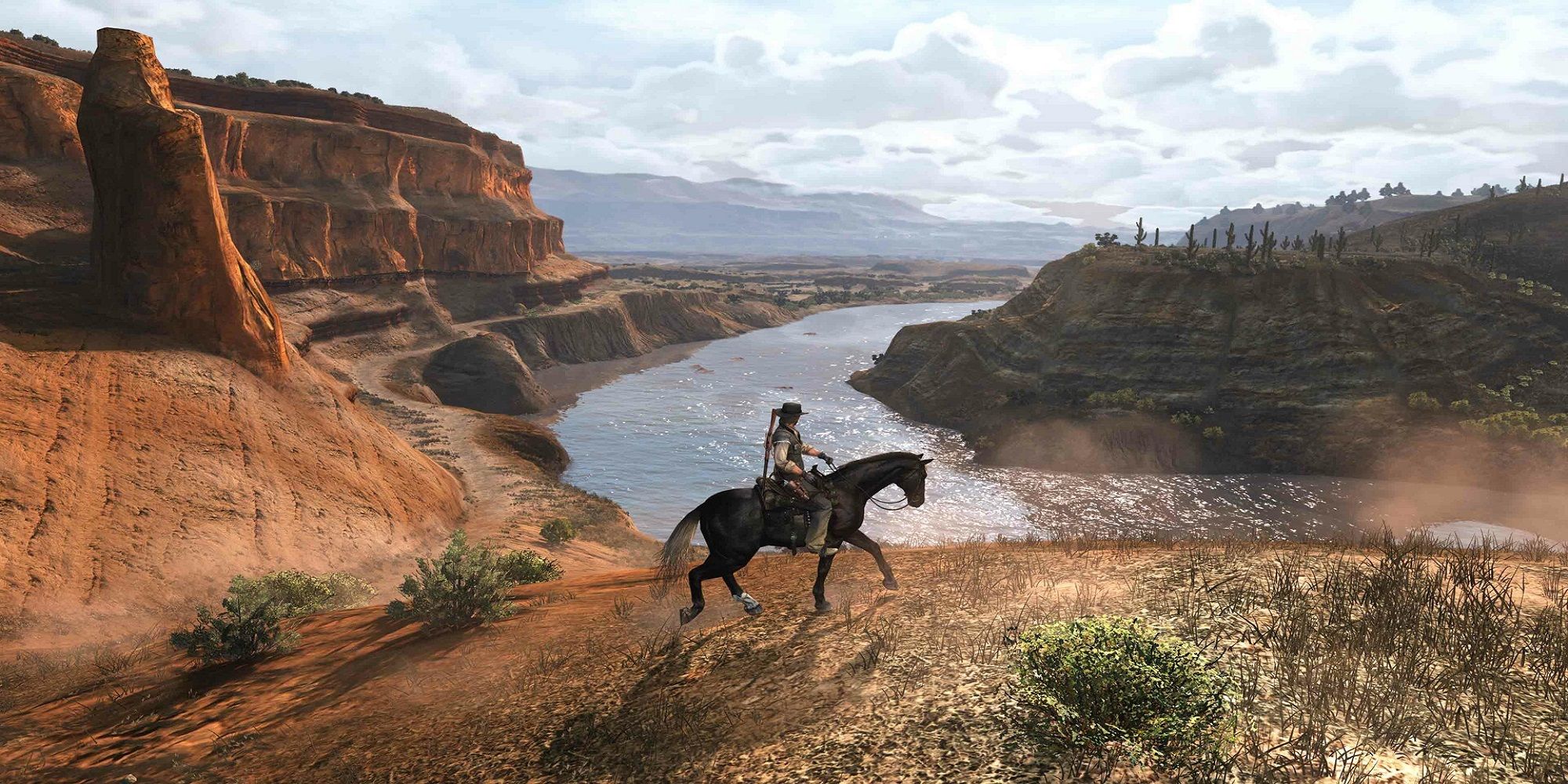 A man rides on a horse in a massive desert