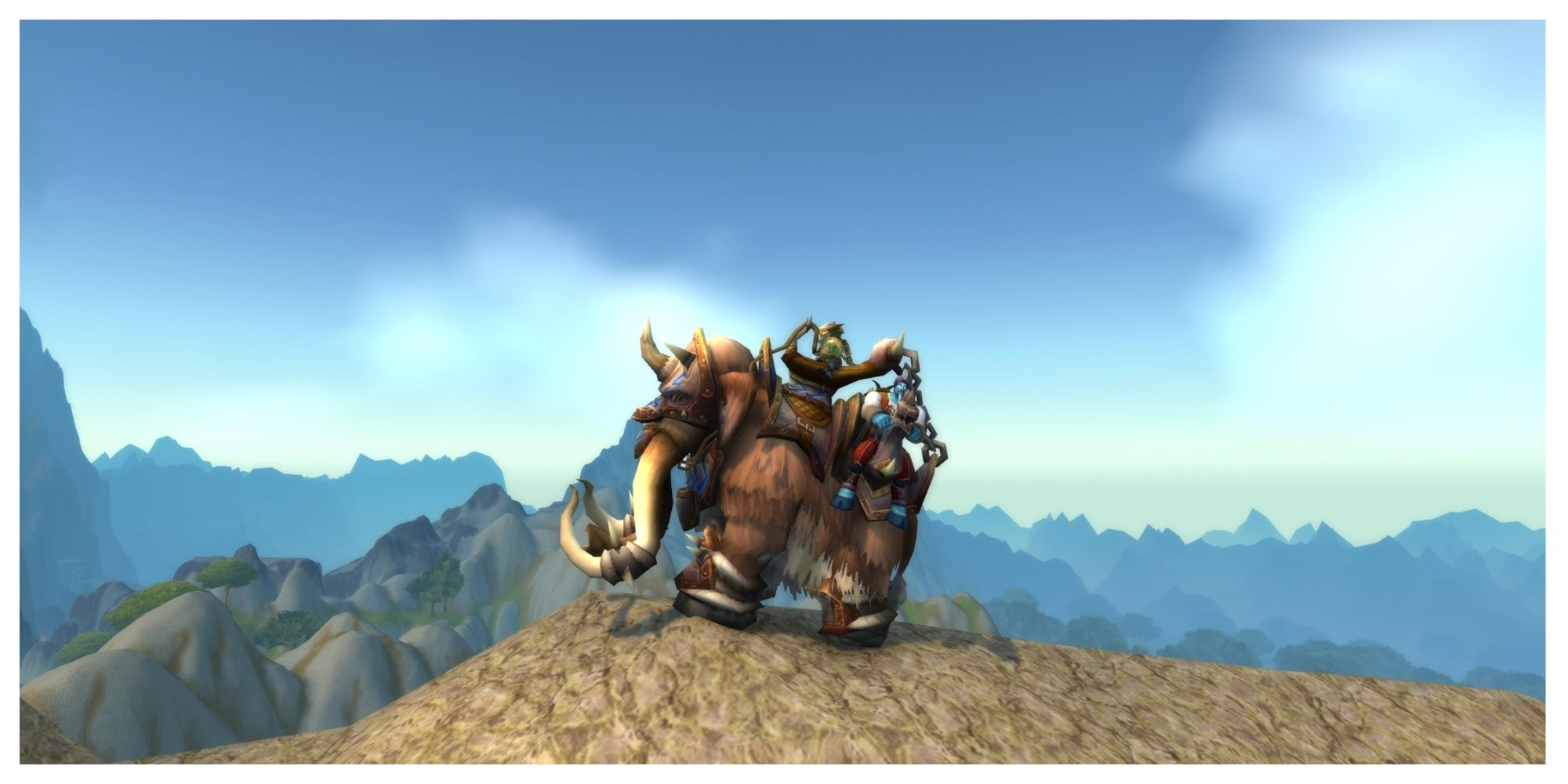 The Traveler's Tundra Mammoth mount on top of a mountain in World of Warcraft.