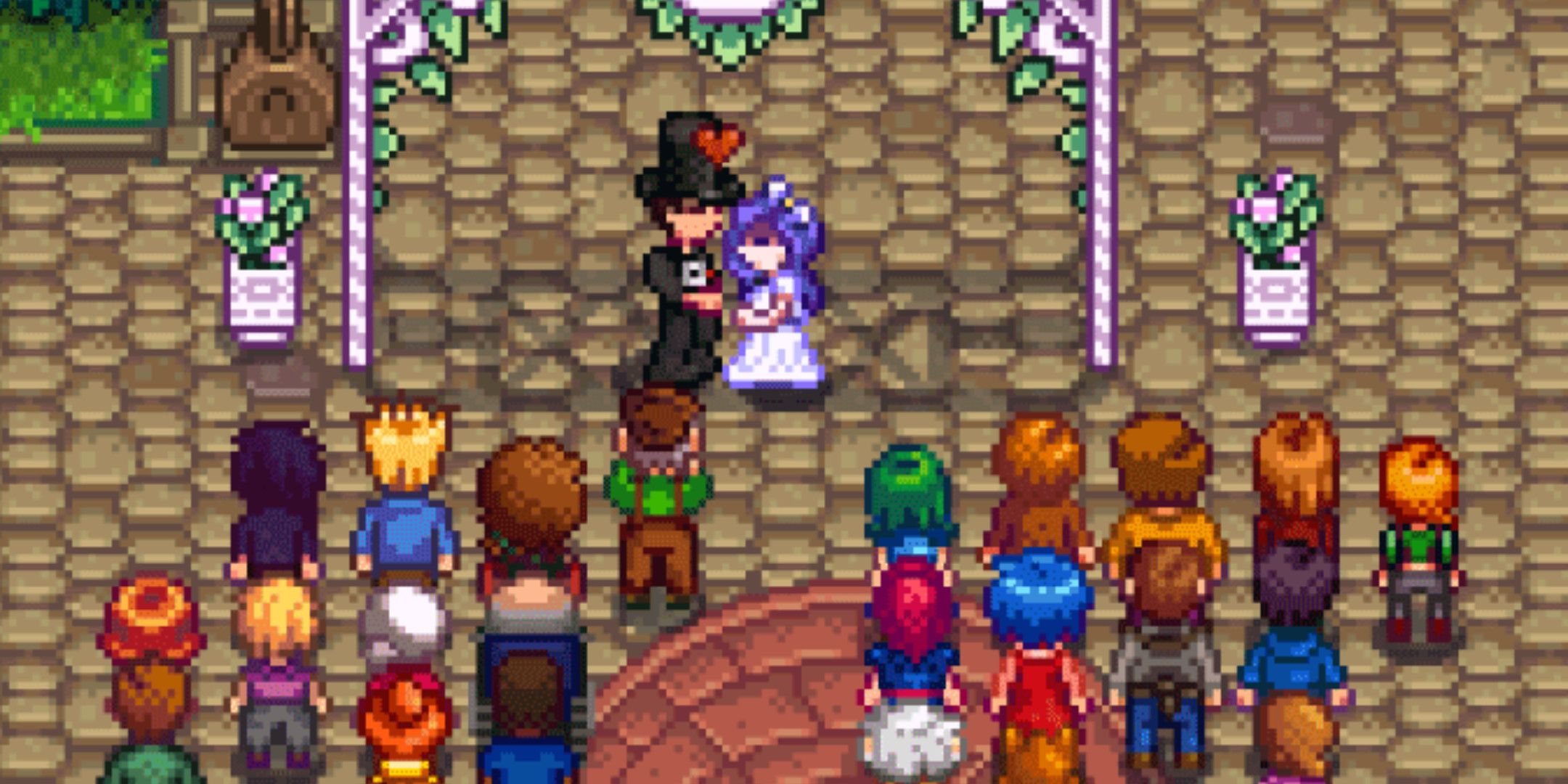 A couple getting married in Stardew Valley with villagers in the crowd.