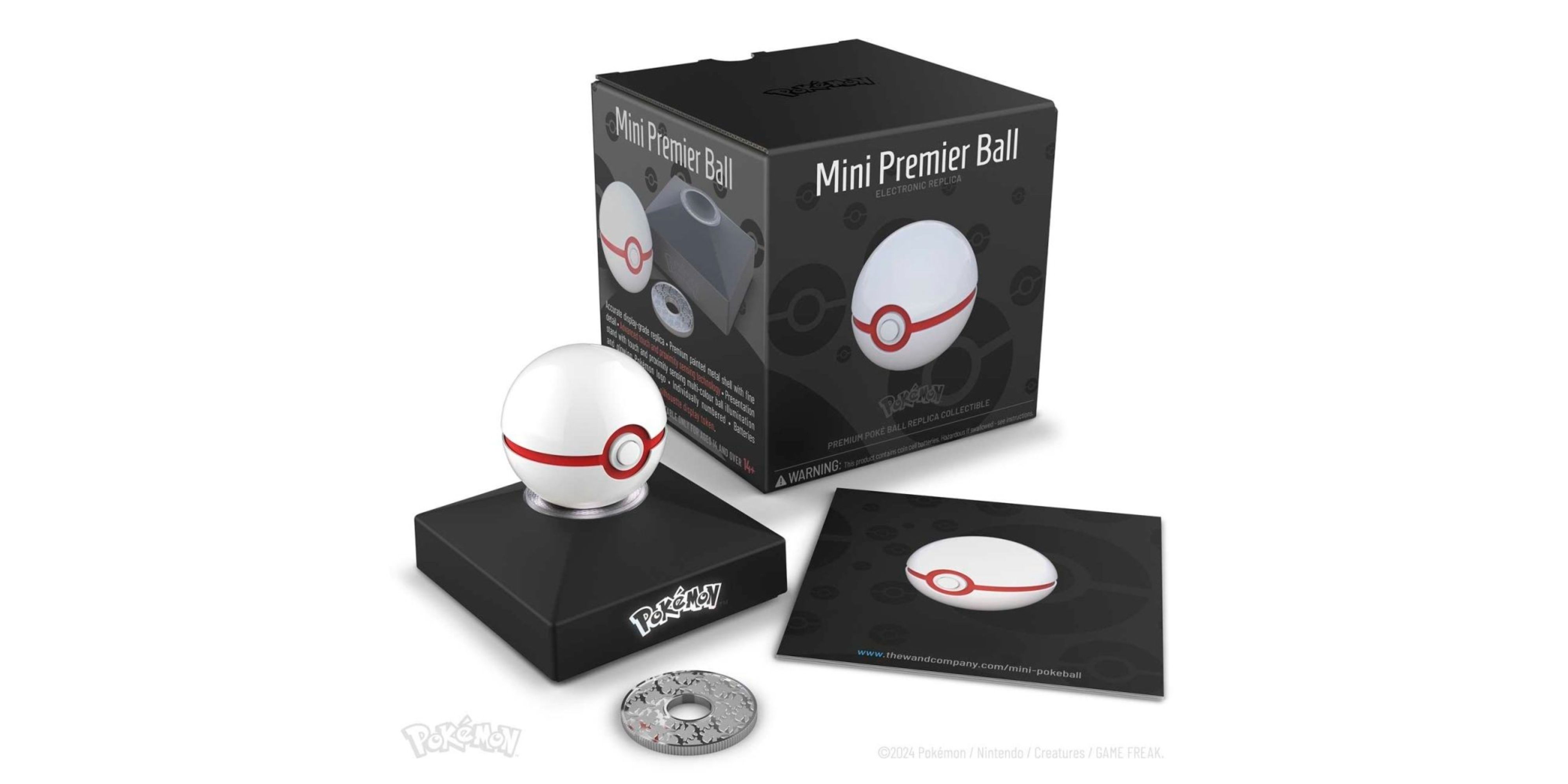 pokemon x the wand company mini premier ball on its stand next to the box.