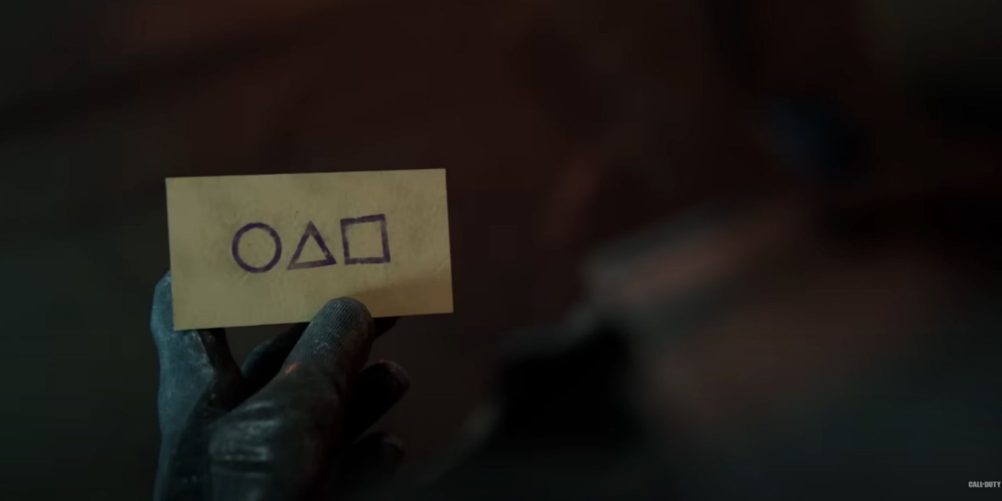 A Call of Duty operator holding a piece of paper with the circle, triangle, and square symbols of Squid Game on it.