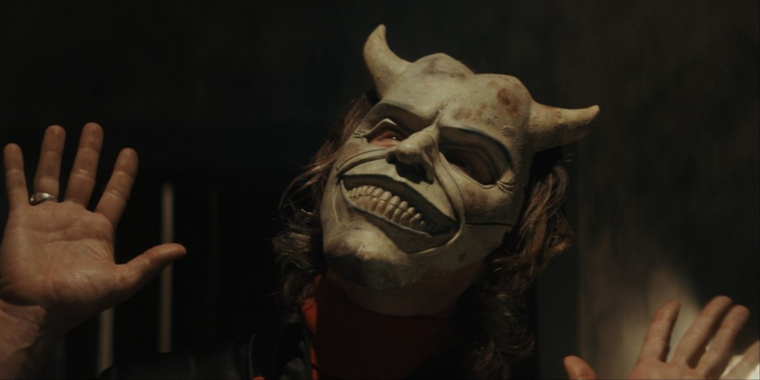 A close-up of Ethan Hawke as The Grabber, wearing his creepy mask, in The Black Phone.