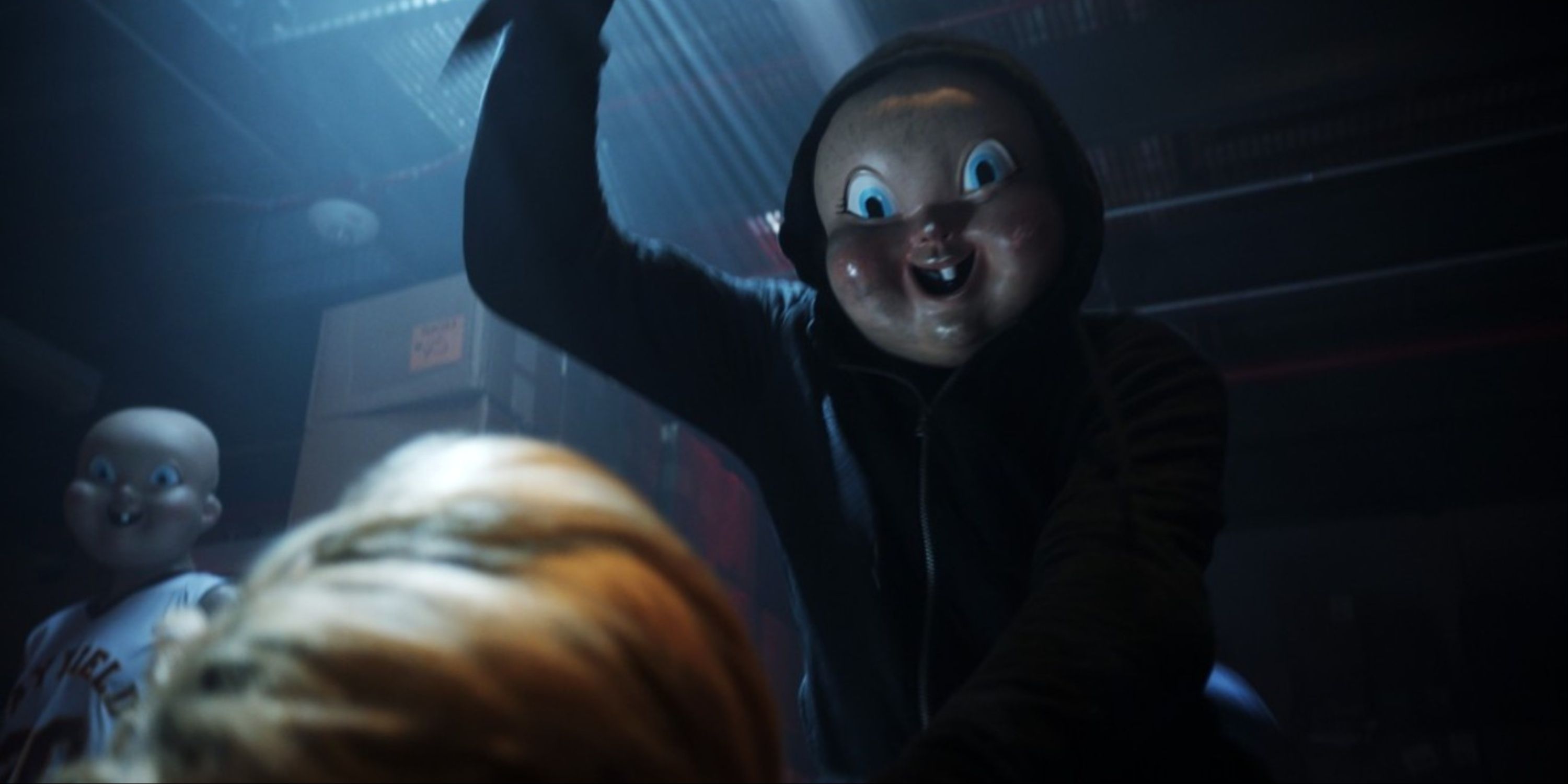 A close-up of the masked killer in the Happy Death Day series about to stab someone.