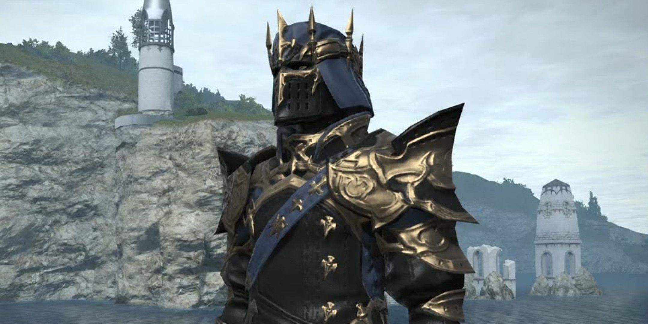 A person in black and gold armor with cliffs and building in the background 