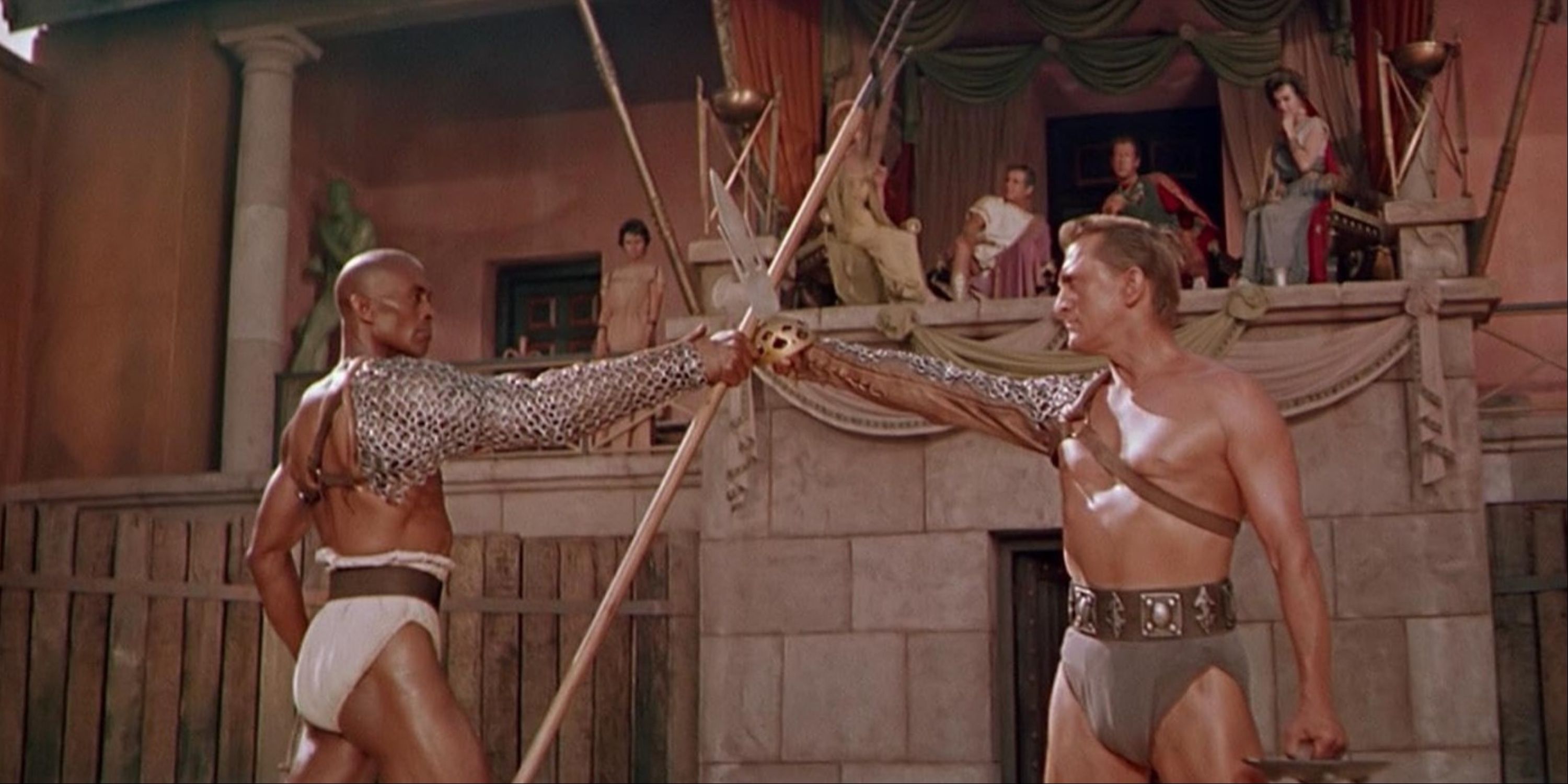 Kirk Douglas' Spartacus locking weapons with Woody Strode&rsquo;s Draba in the gladiator arena before an audience in Kubrick&rsquo;s Spartacus.