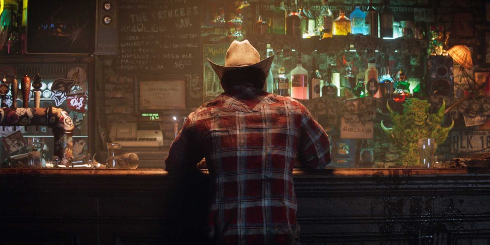 Logan sitting at a bar in Insomniac's Wolverine.