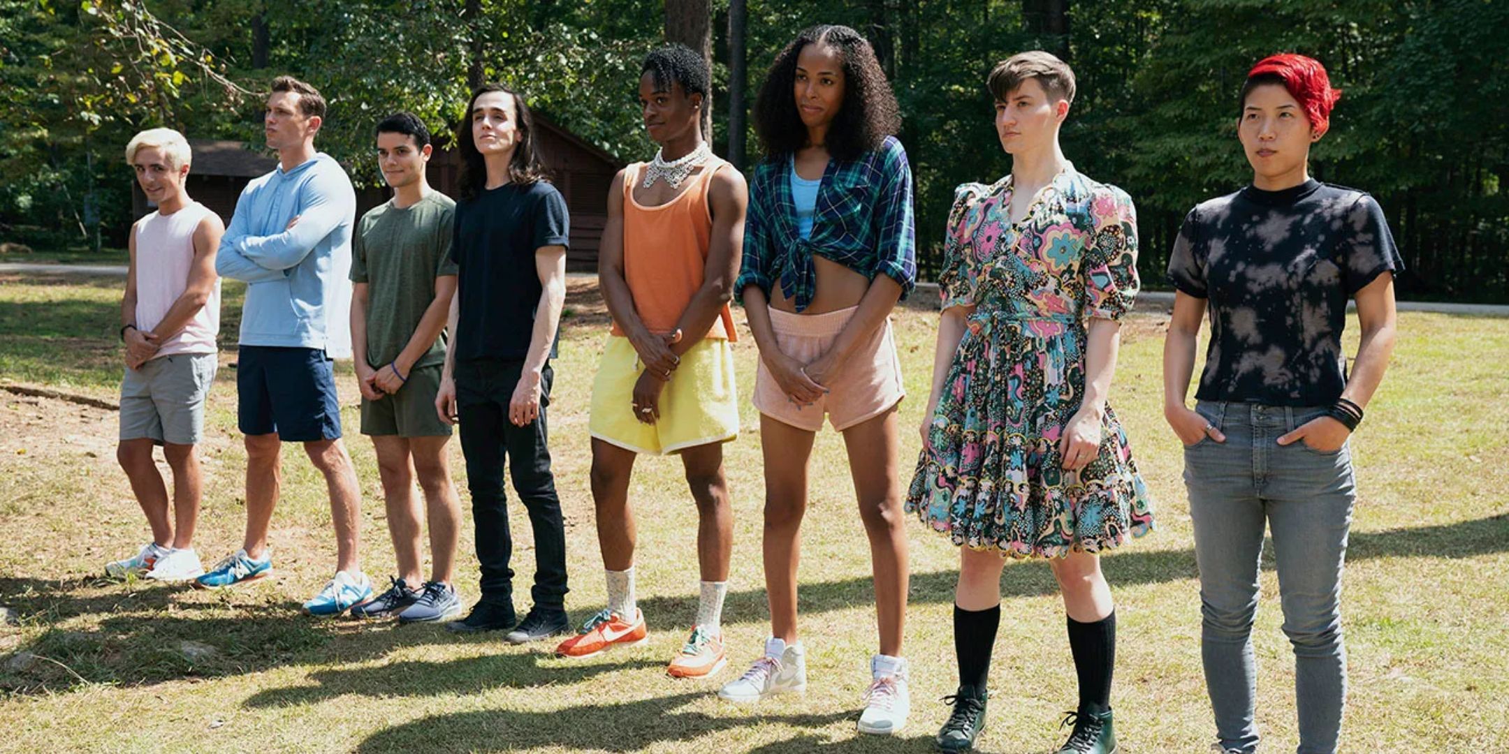 A group of teenagers stand outside in them/them. 