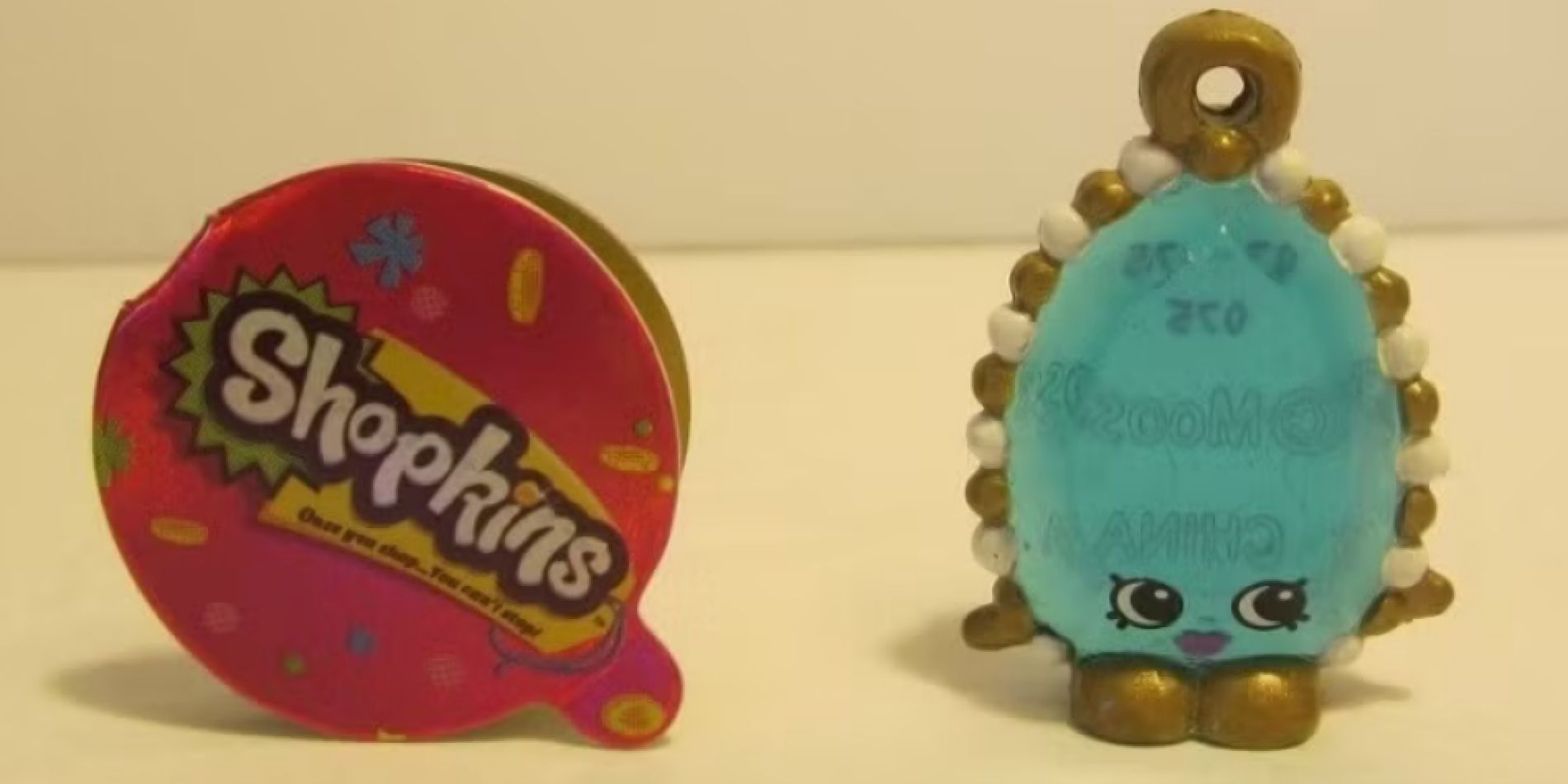 Image of the Brenda Brooch Shopkin next to her tag.