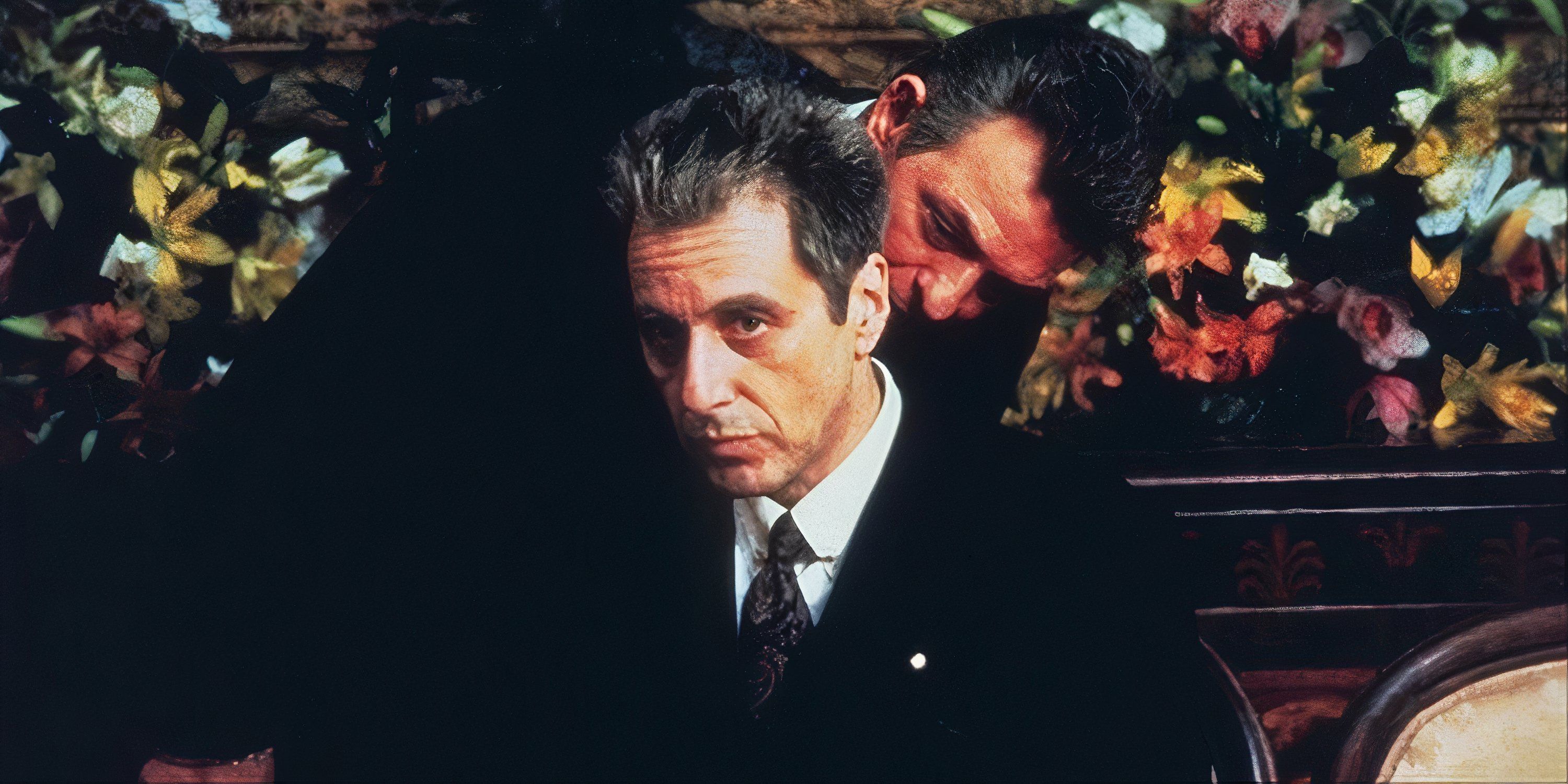 Al Pacino in The Godfather Part 3 with a character speaking into his ear.