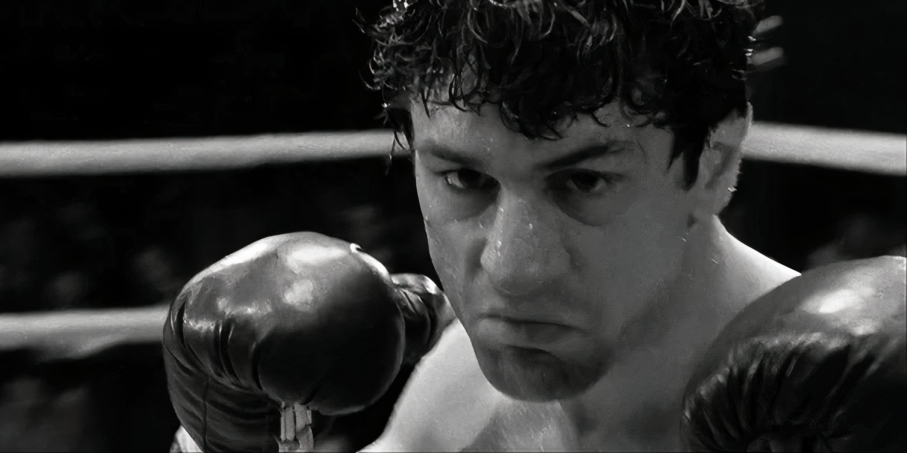 Black-and-white still of Robert De Niro as boxer Jake LaMotta in the ring with his guard up in Raging Bull.