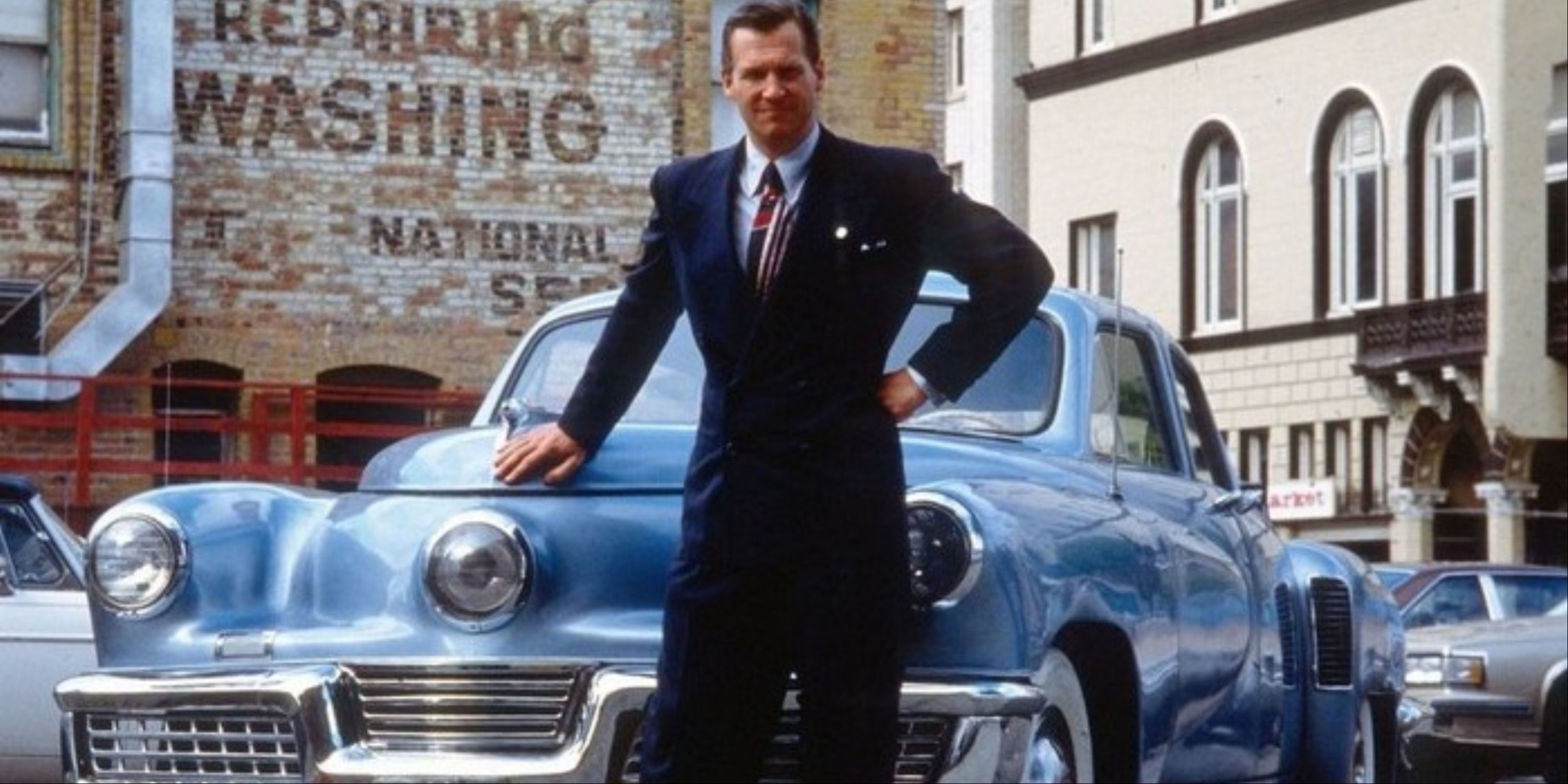 Jeff Bridges as Preston Tucker proudly standing in front of his car in Tucker The Man and his Dream.