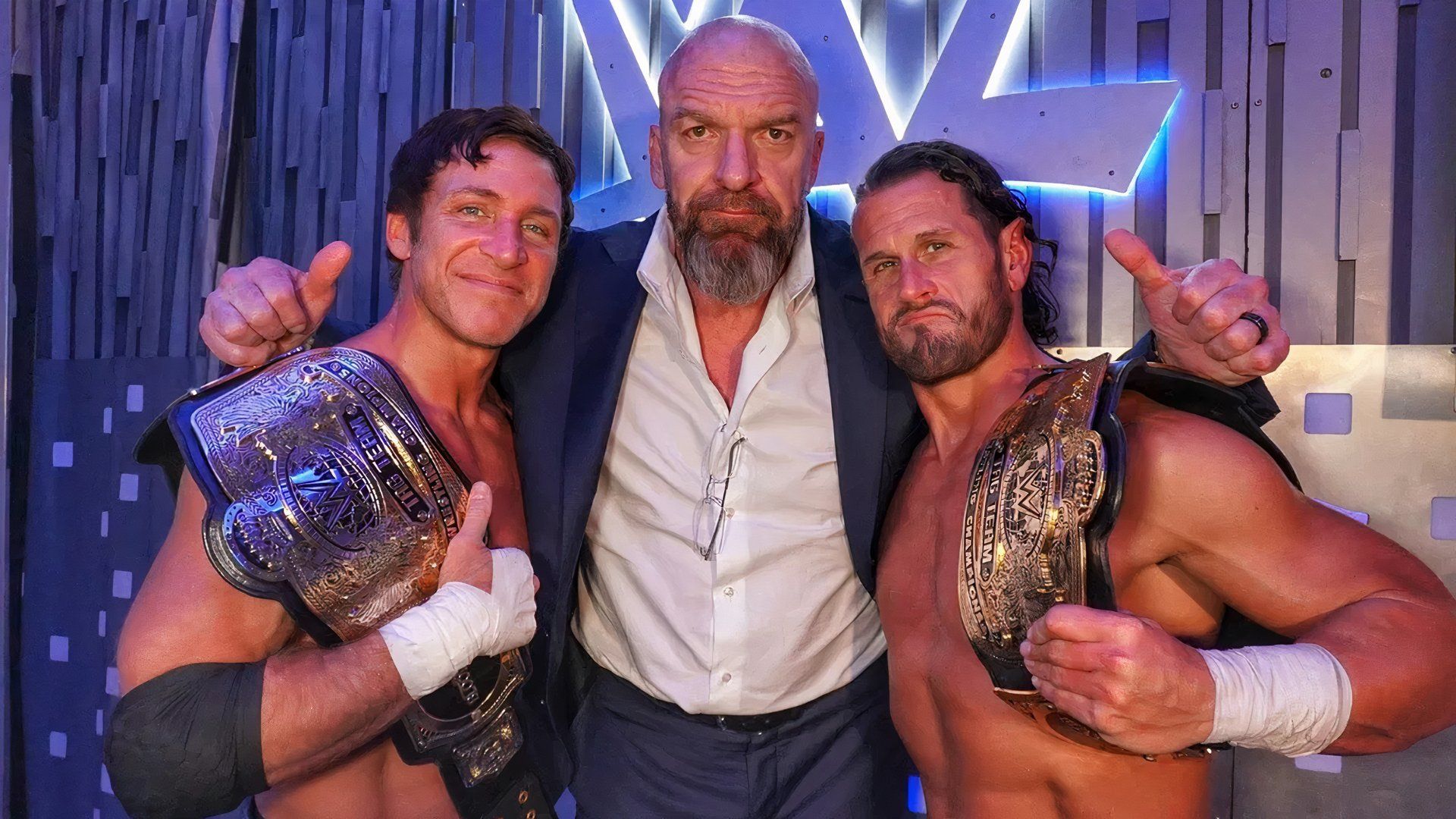 The Motor City Machine Guns, Chris Sabin and Alex Shelley, posing with Triple H on WWE Smackdown.