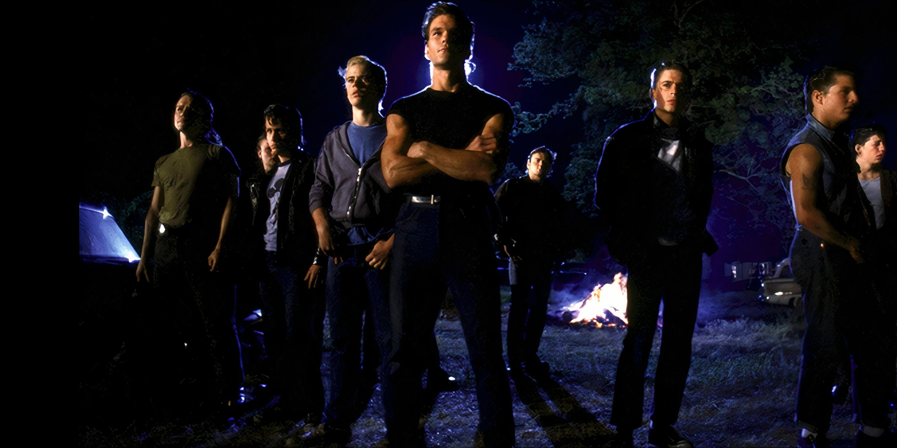 Patrick Swayze and the rest of the cast confronting a group in The Outsiders.