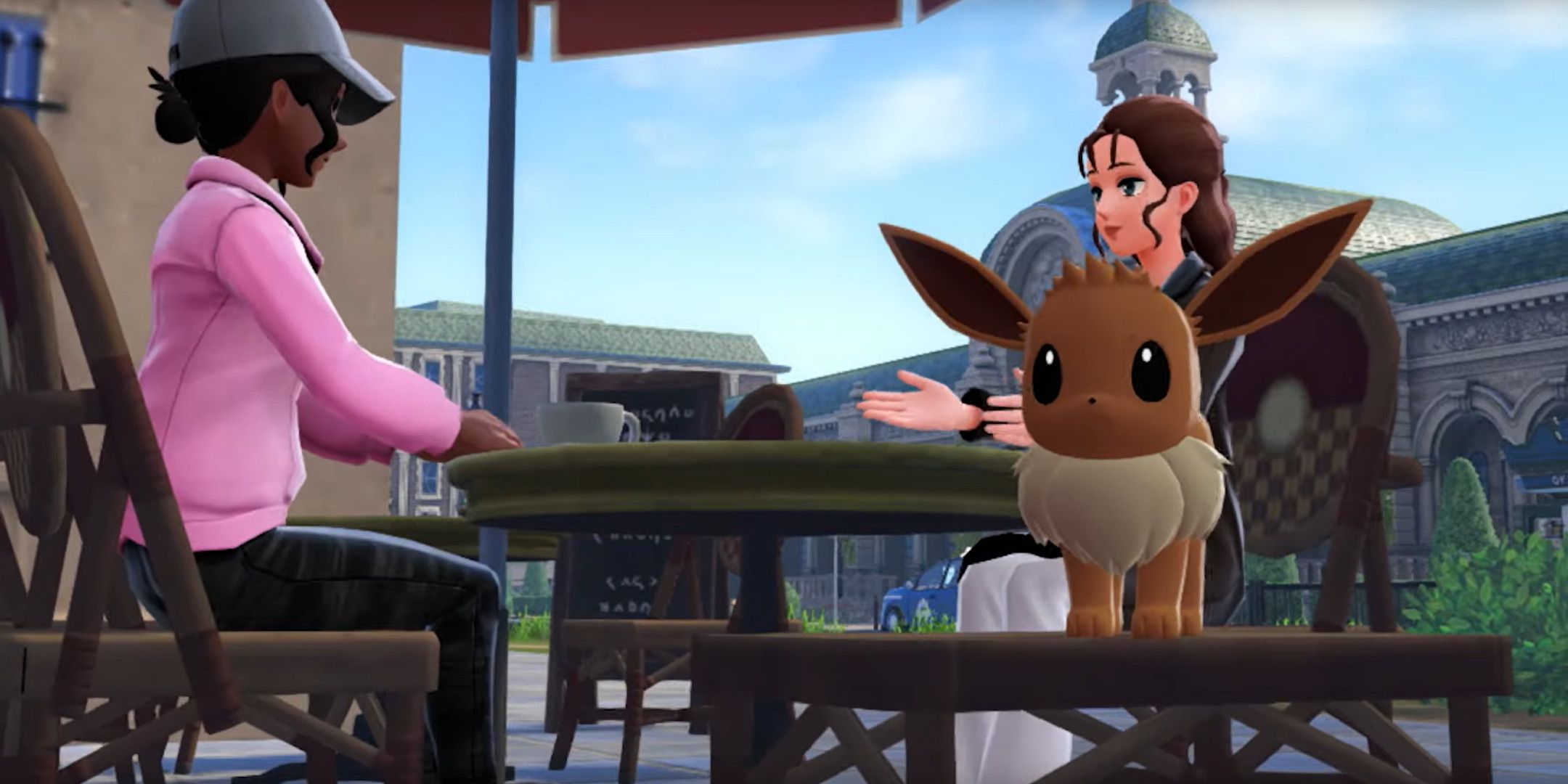 Two people sat talking with an Eevee in the foreground