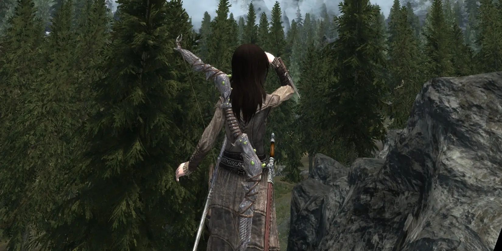 Skyrim: A flexible dragonborn poses in front of trees.