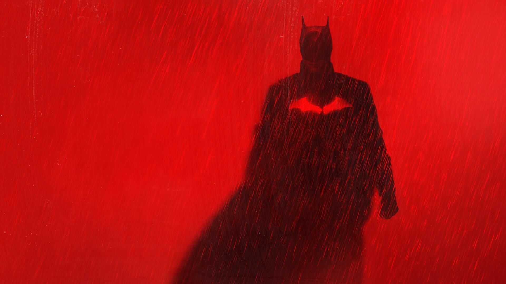 Poster of The Batman in rain with a red background.