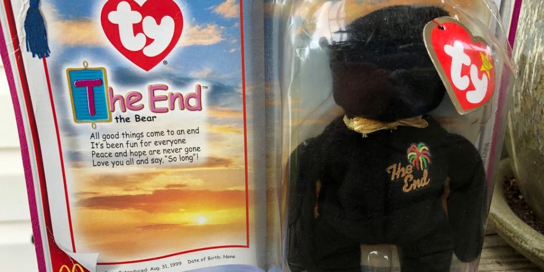 A black bear sits in a box labled 'the End'