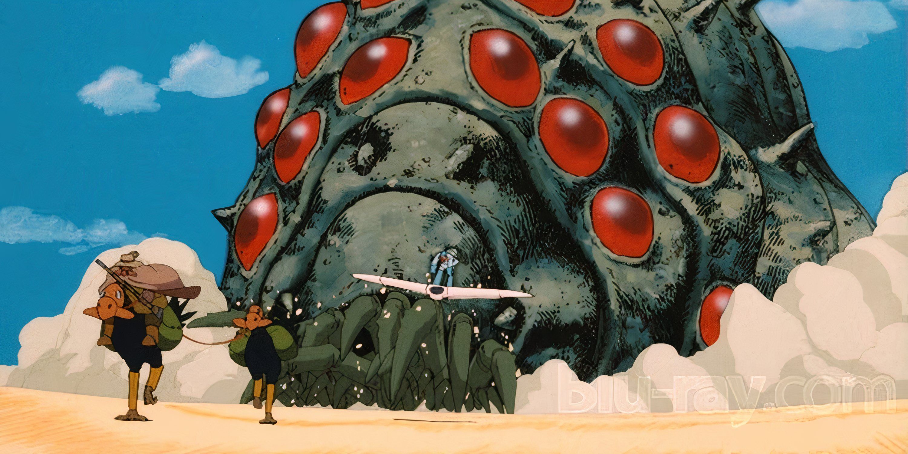 A giant bug chases a couple of wanderers in Nausicaa of the Valley of the Wind.