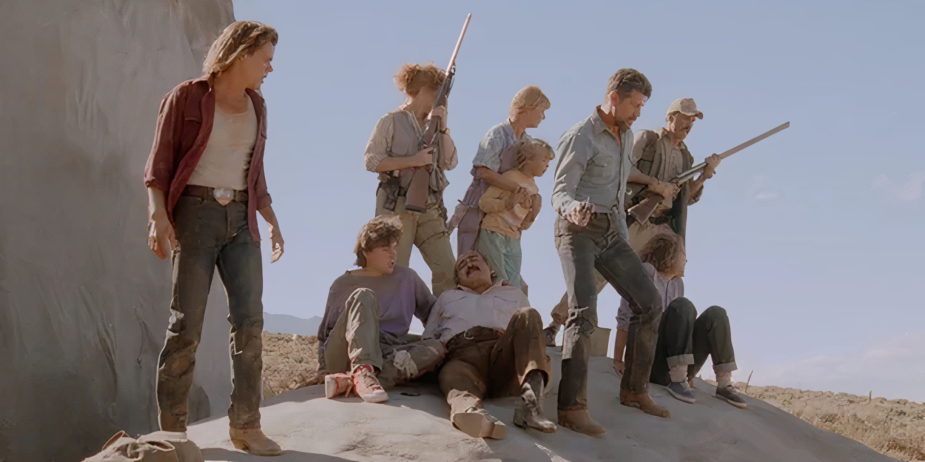 A group of people stand on a rock in the desert in Tremors.