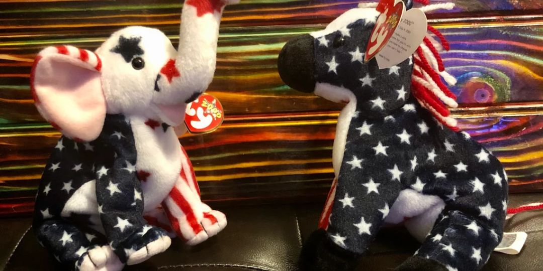 An elephant and a donkey, both covered in the American flag, sit on a couch