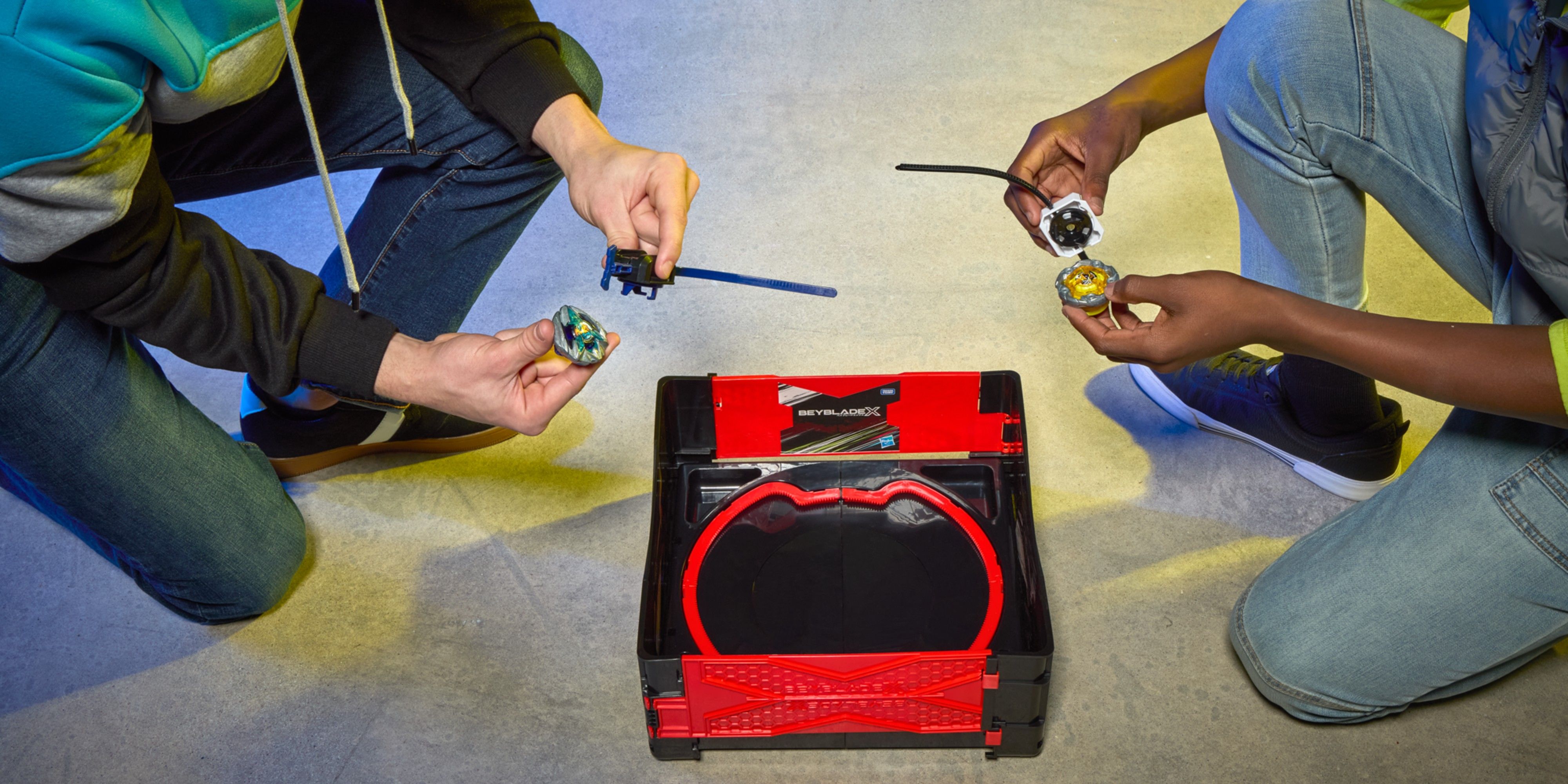 kids using the clash and carry beyblade arena.