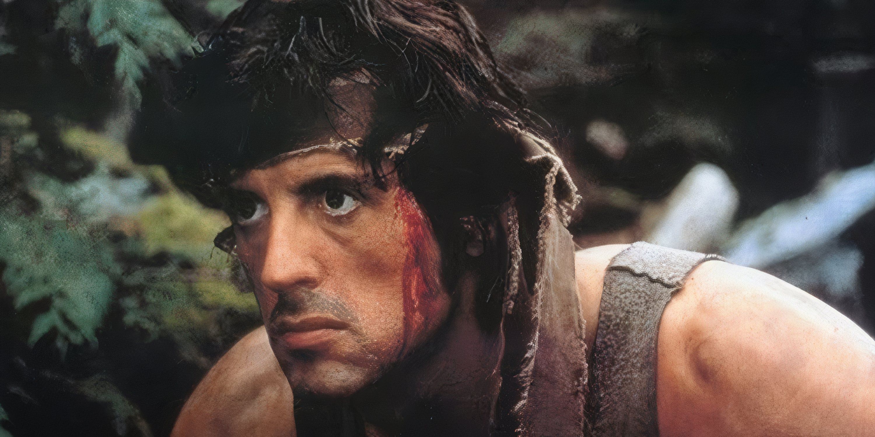 John Rambo hides in the forest with blood on his face in First Blood.