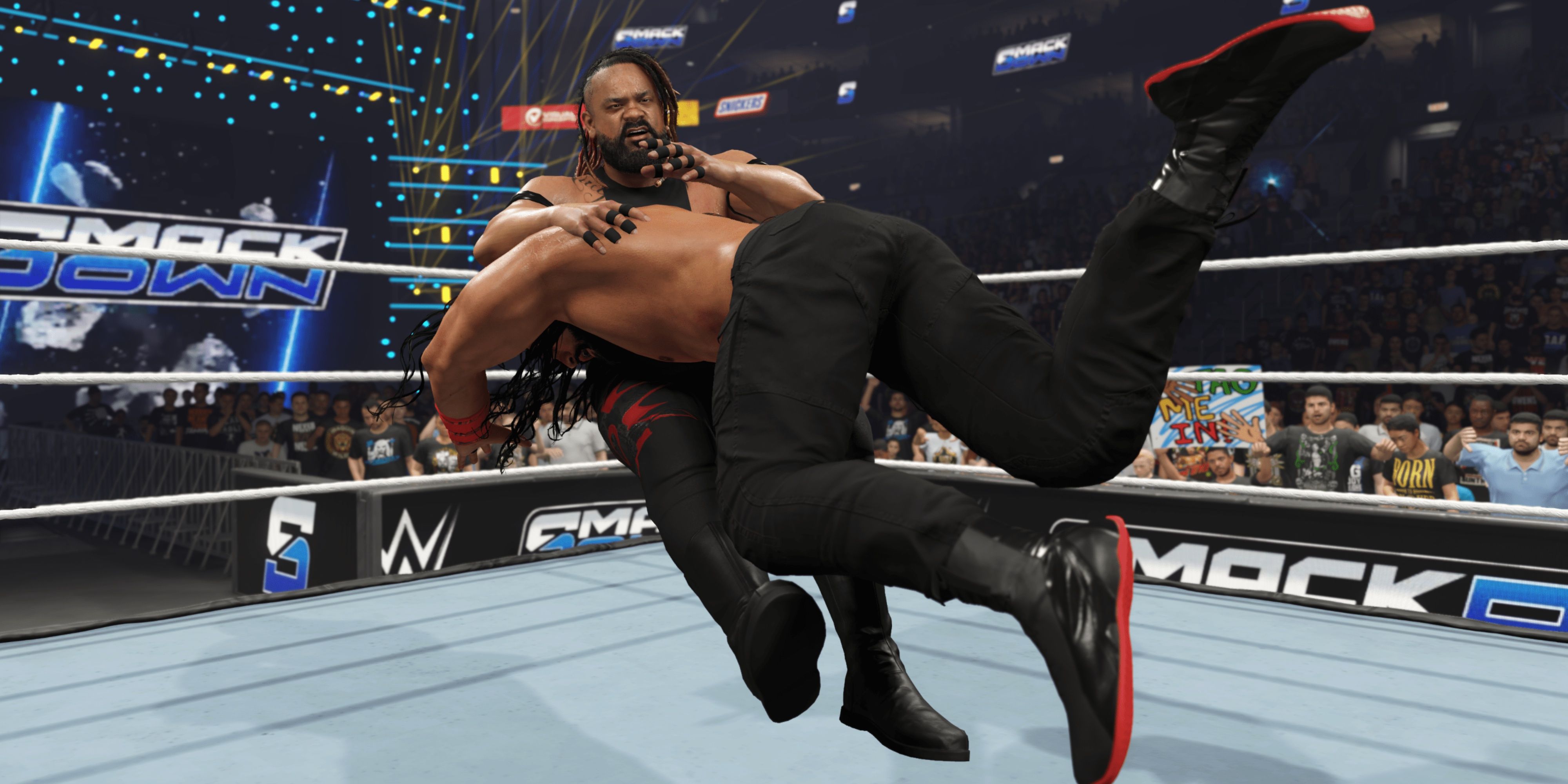 roman reigns hitting jacob fatu with a spear in wwe 2k25.
