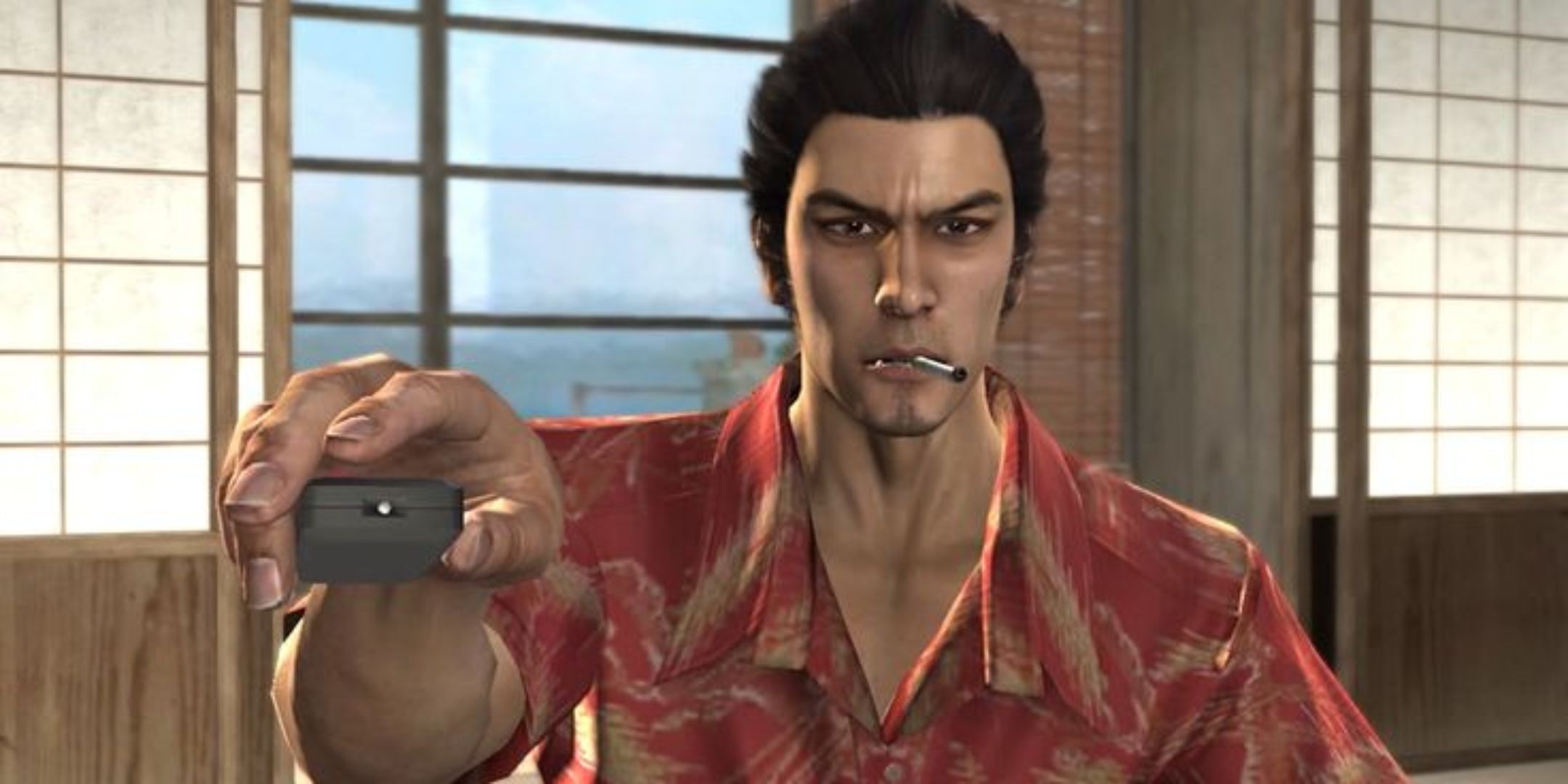 Yakuza 3 screenshot of Kiryu smoking a cigarette and holding a remote.
