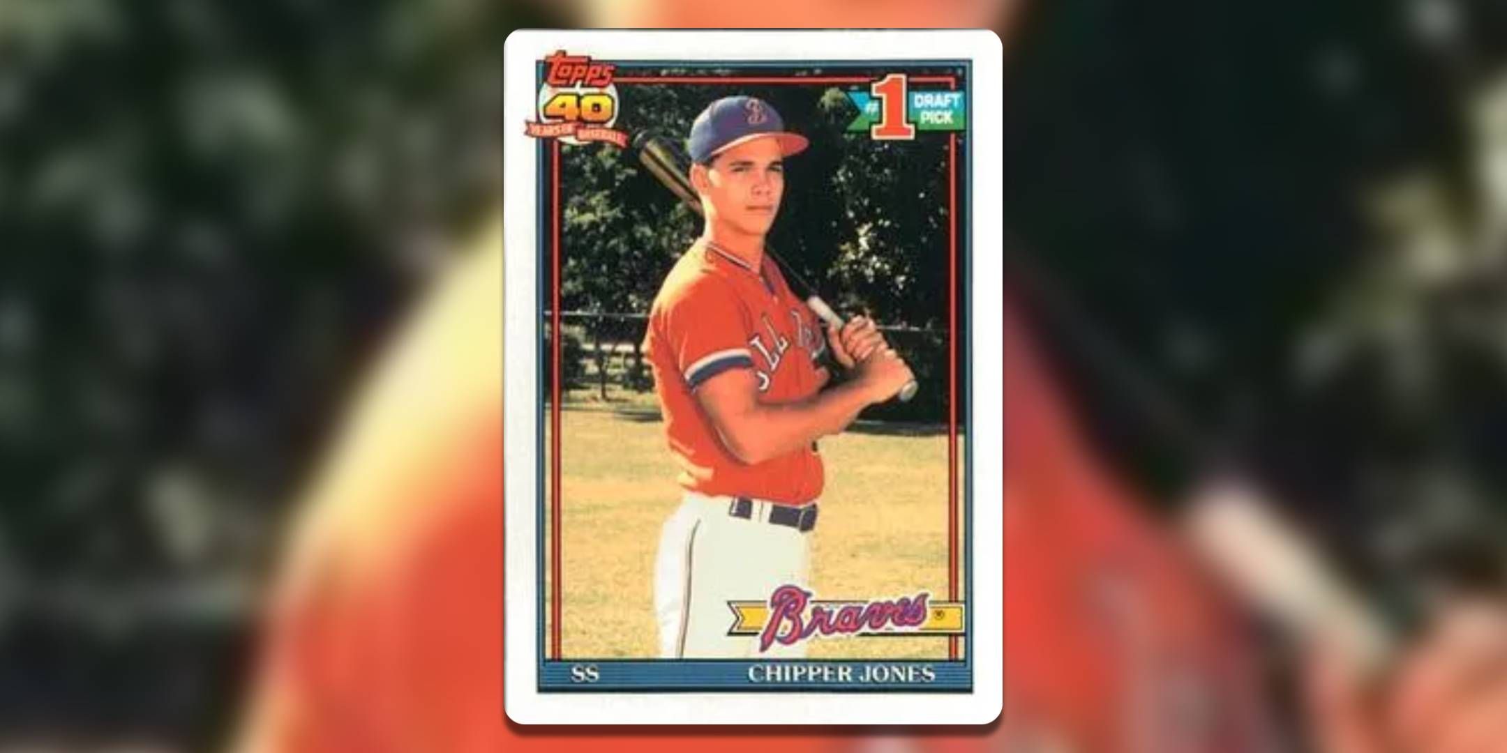 In this baseball card, Chipper Jones stands on a field with a baseball bat resting on his shoulder.