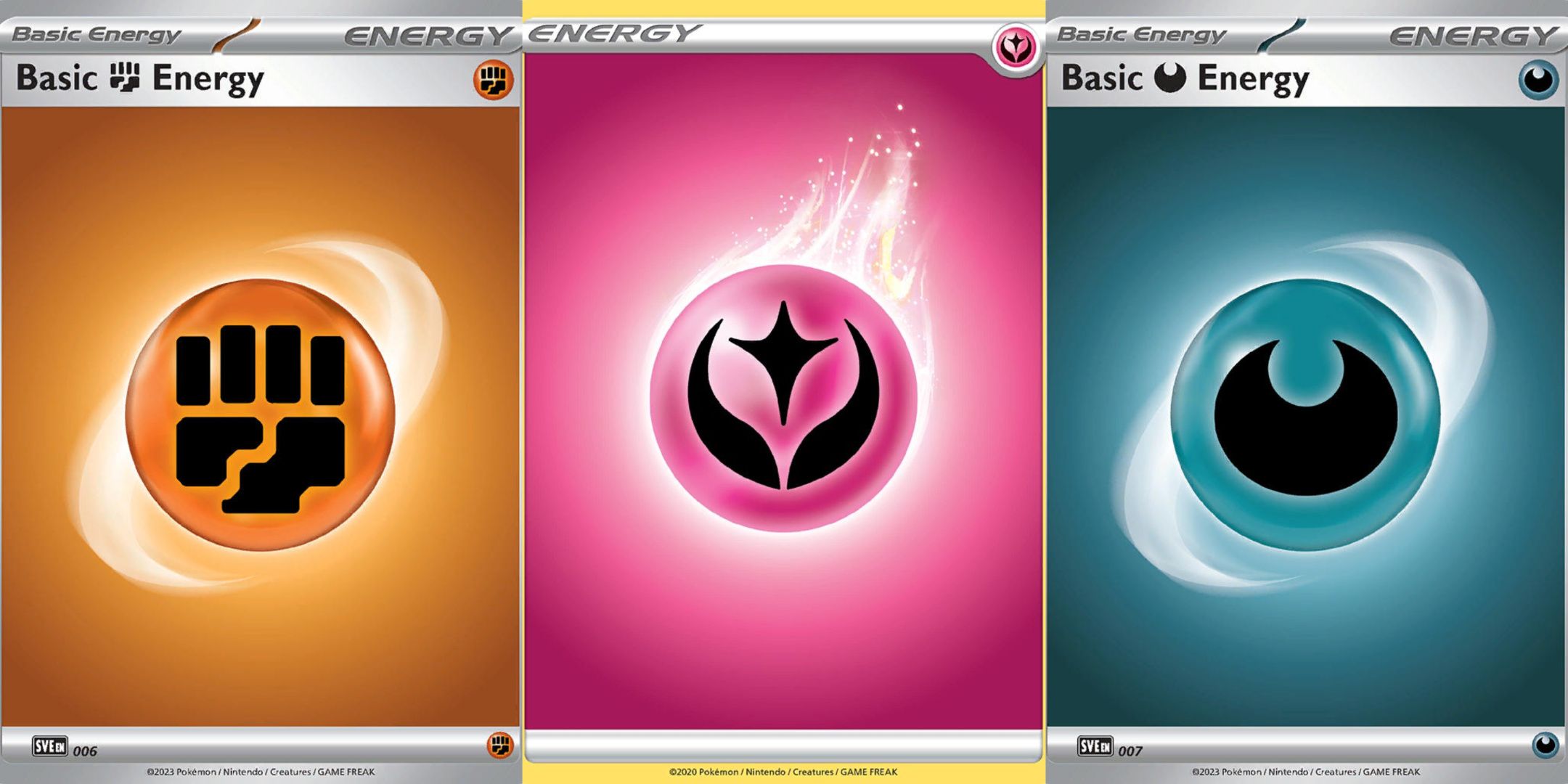 Pokemon TCG, three different energy cards. Specifically the Fighting Energy Card, the Fairy Energy Card, and the Darkness Energy Card.