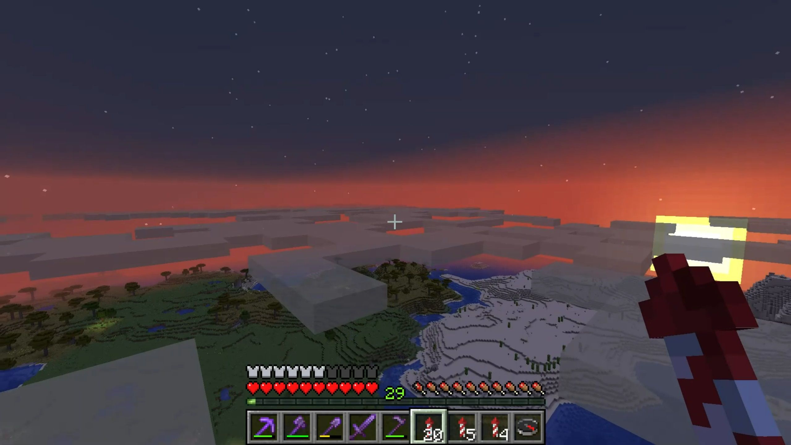 A view of the landscape from above the clouds, with the sun setting on the right. The player is holding a rocket in Minecraft.