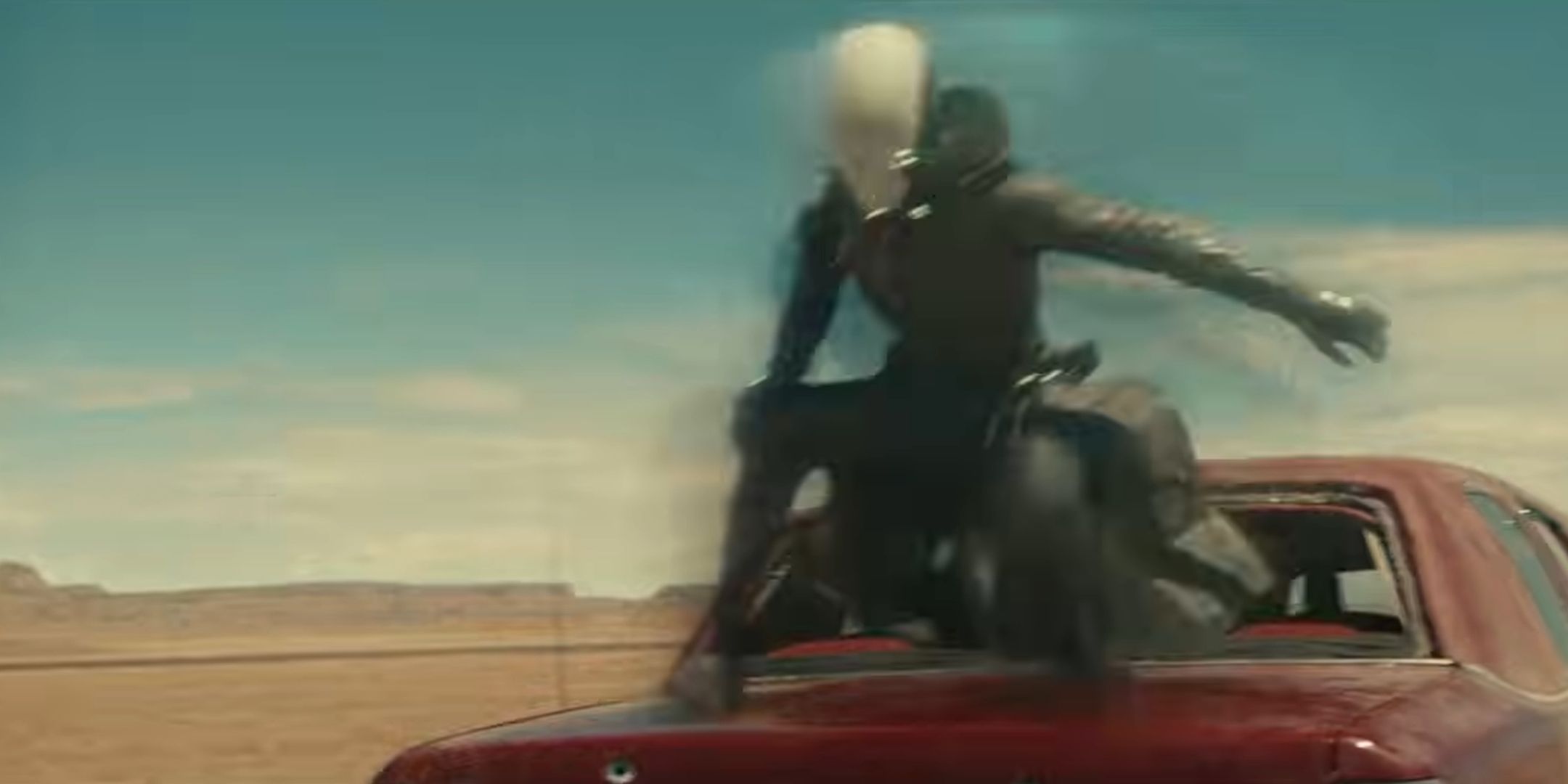 Ghost fizzing above the trunk of a red car in Thunderbols.