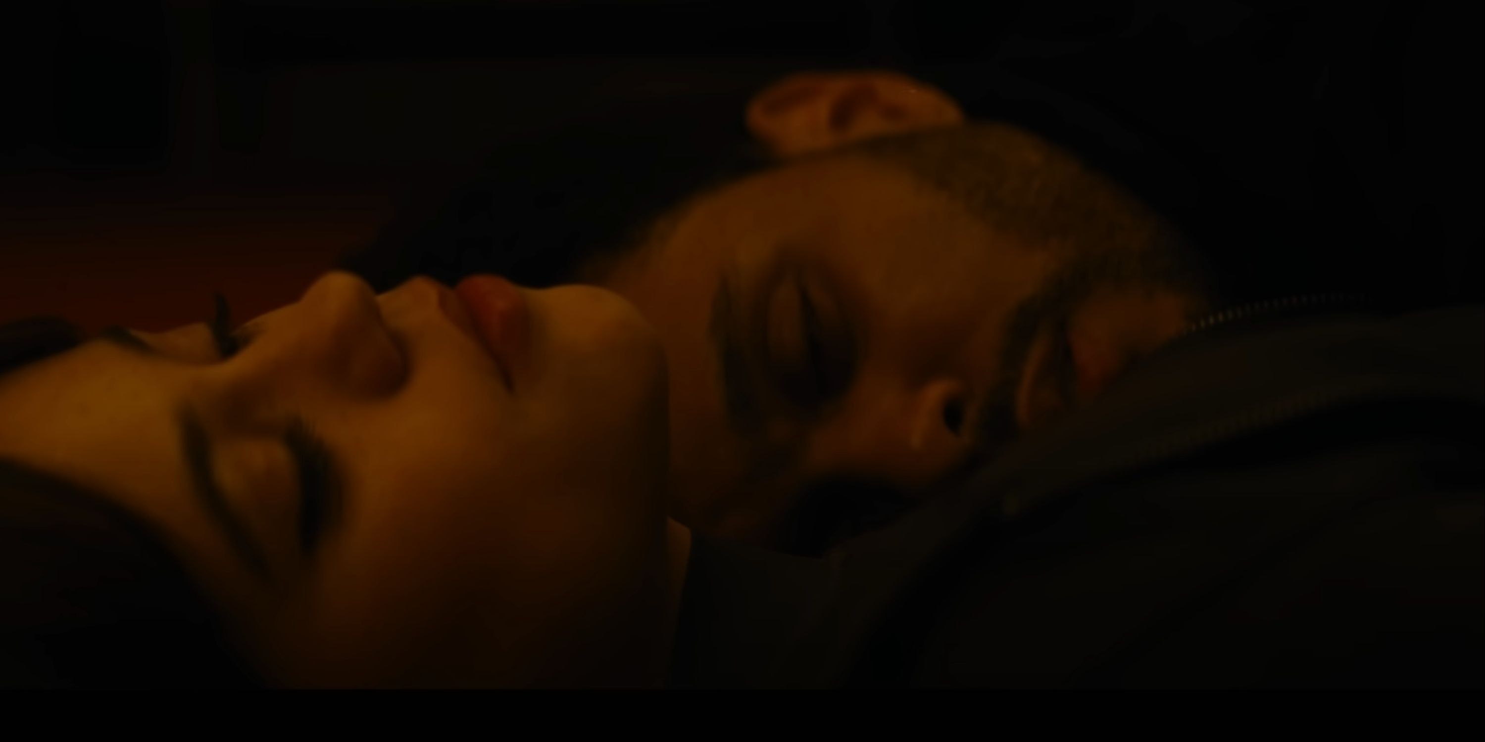Abel and Jenna Ortega's characters resting on each other in Hurry Up Tomorrow.
