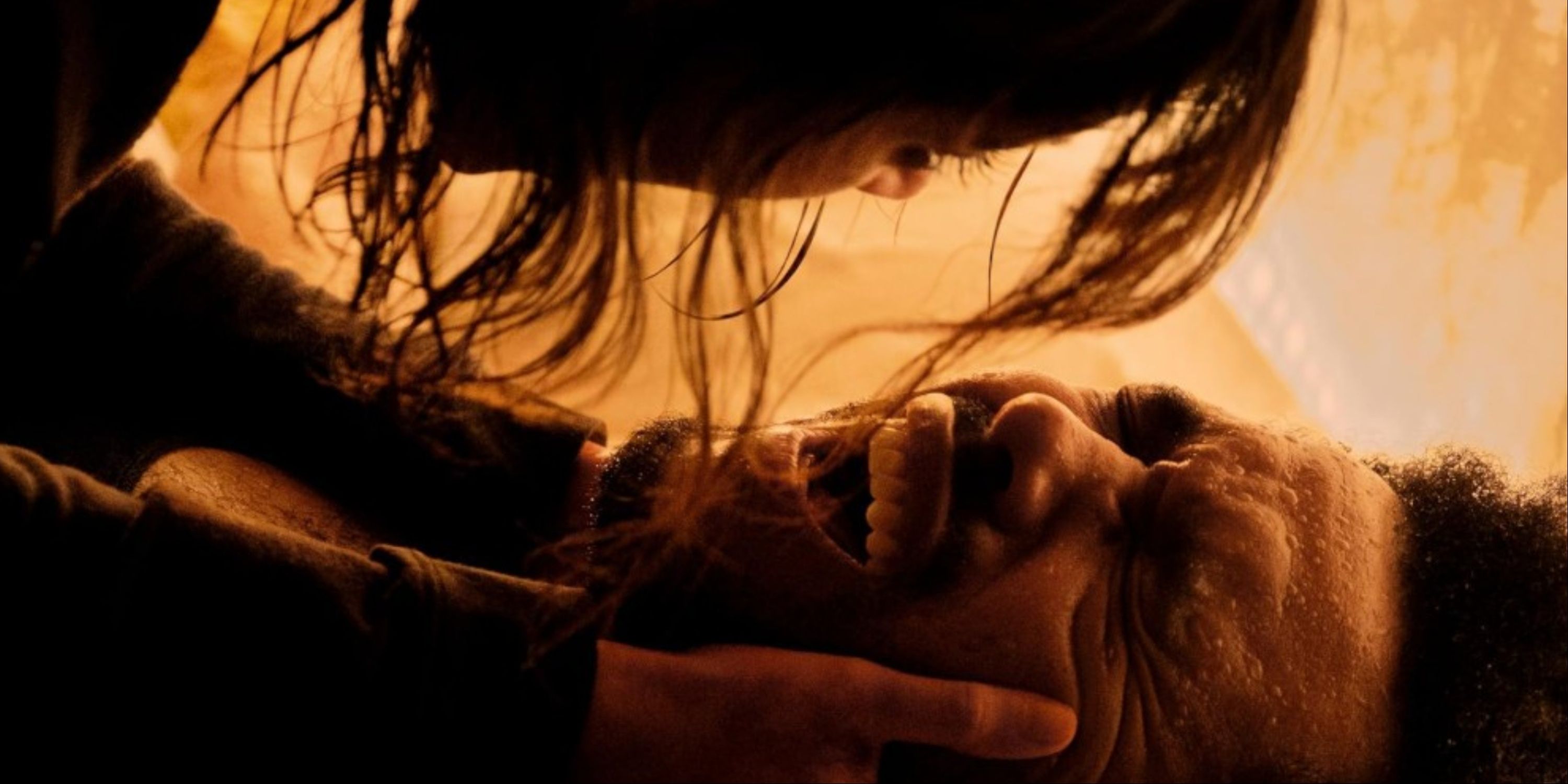 The Weeknd screaming while tied to a bed an Jenna Ortega's character holding his face over him in a scene from Hurry Up Tomorrow.