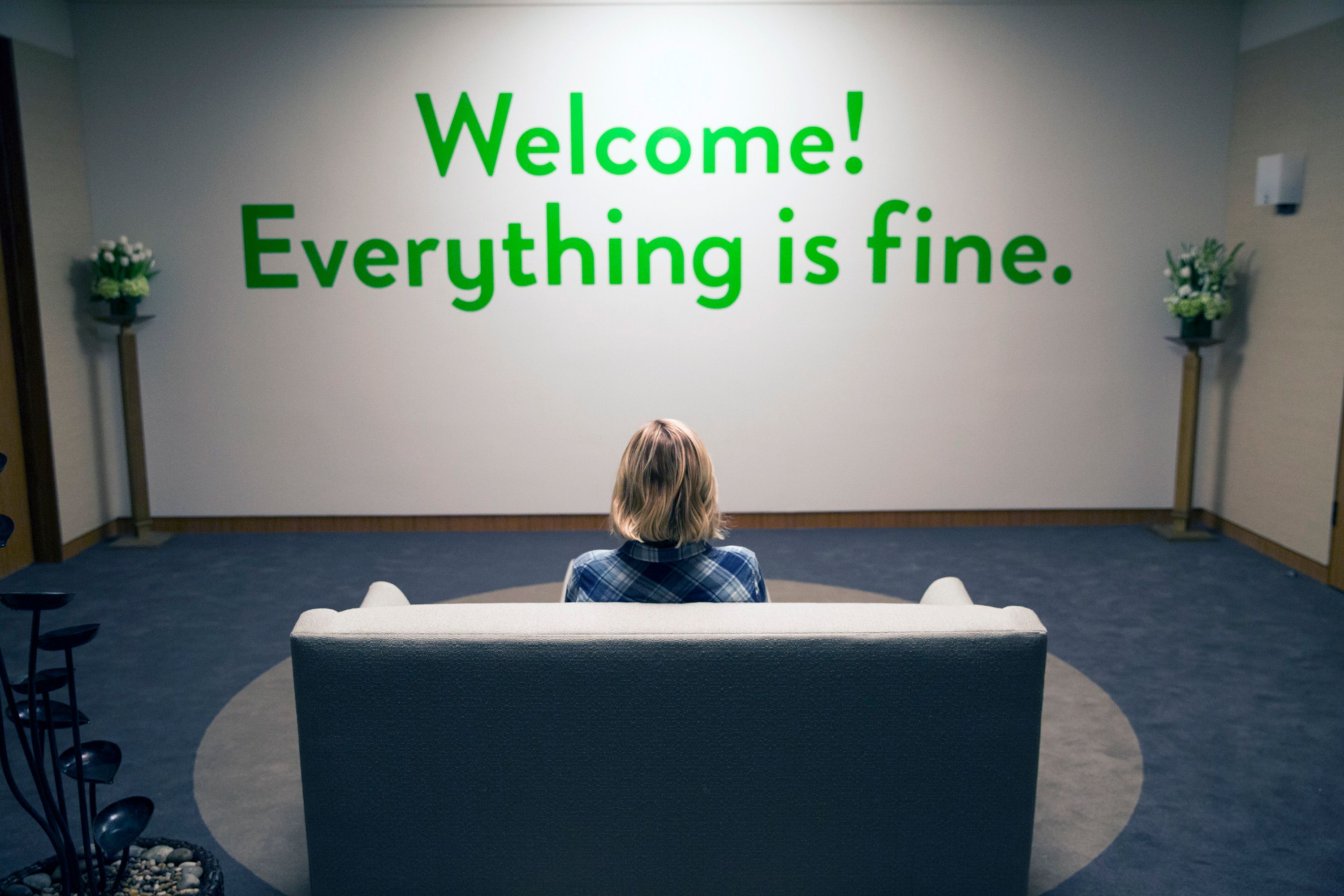 A still image from the NBC series 'The Good Place' with a wall that says