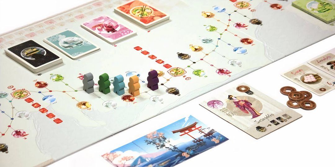 Five players standing around the halfway point of the board game in Tokido.